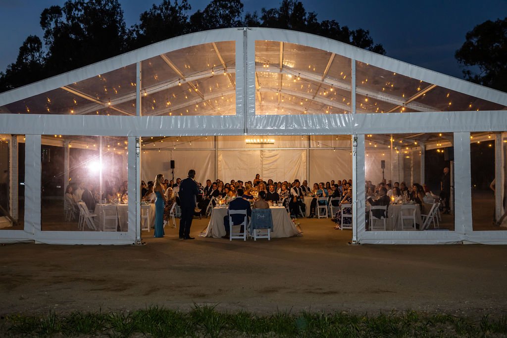 Magnolia Pavilion glowing at night during a Tar Creek Ranch wedding reception
