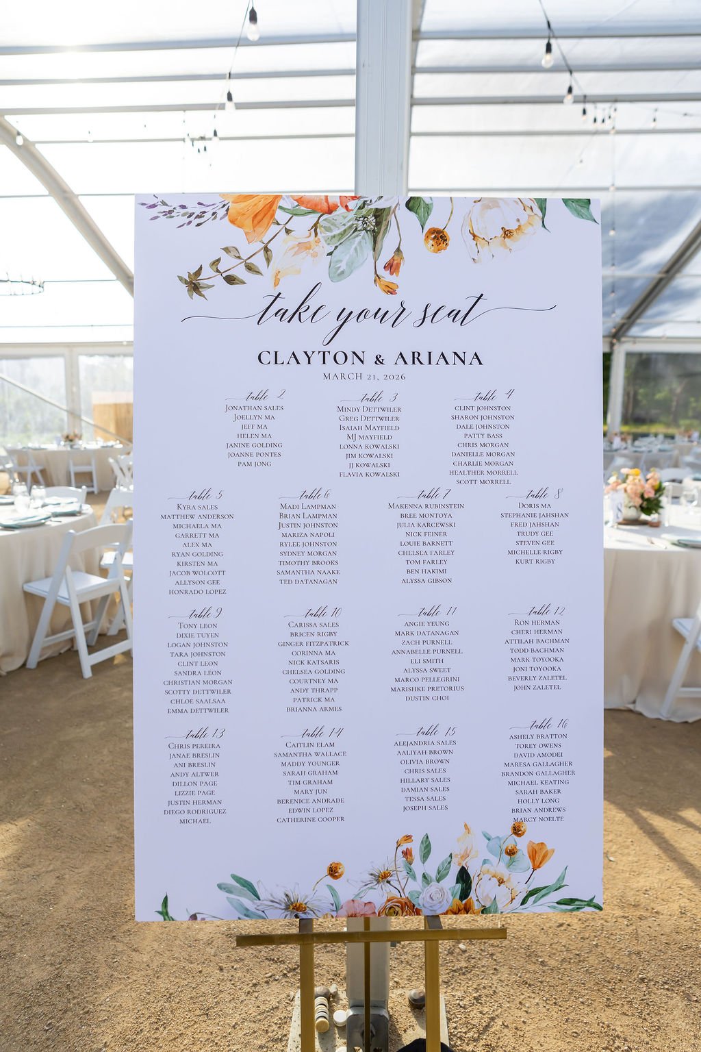 Floral wedding seating chart beneath the Magnolia Pavilion at Tar Creek Ranch