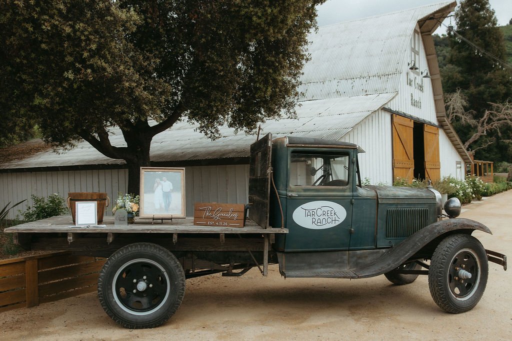 Vintage Tar Creek Ranch truck holding wedding displays and guest details