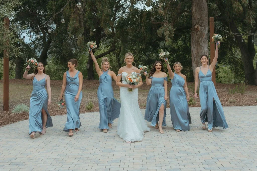 Bride and bridesmaids in dusty blue dresses at a California ranch wedding