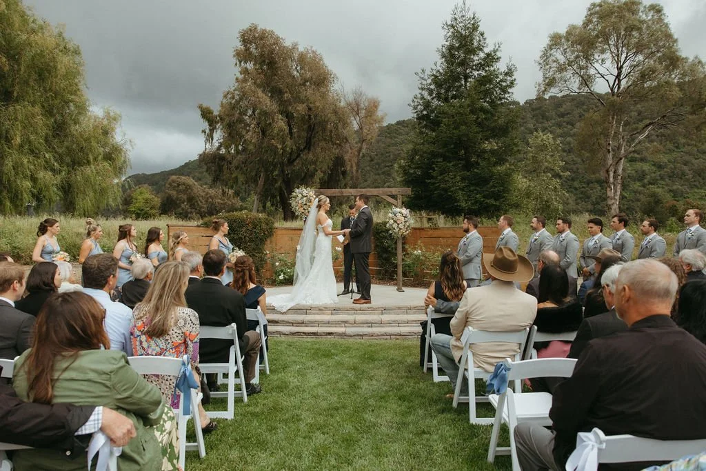 Lindsey and Garrett exchanging vows during a Central Coast garden wedding