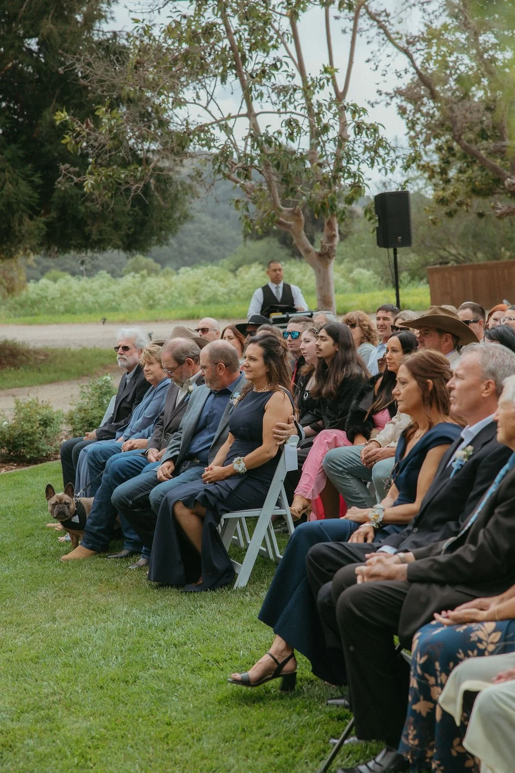 Guests watching an outdoor wedding ceremony at Tar Creek Ranch