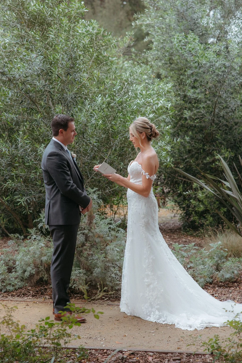 Lindsey and Garrett reciting private vows beneath the olive trees at Tar Creek Ranch