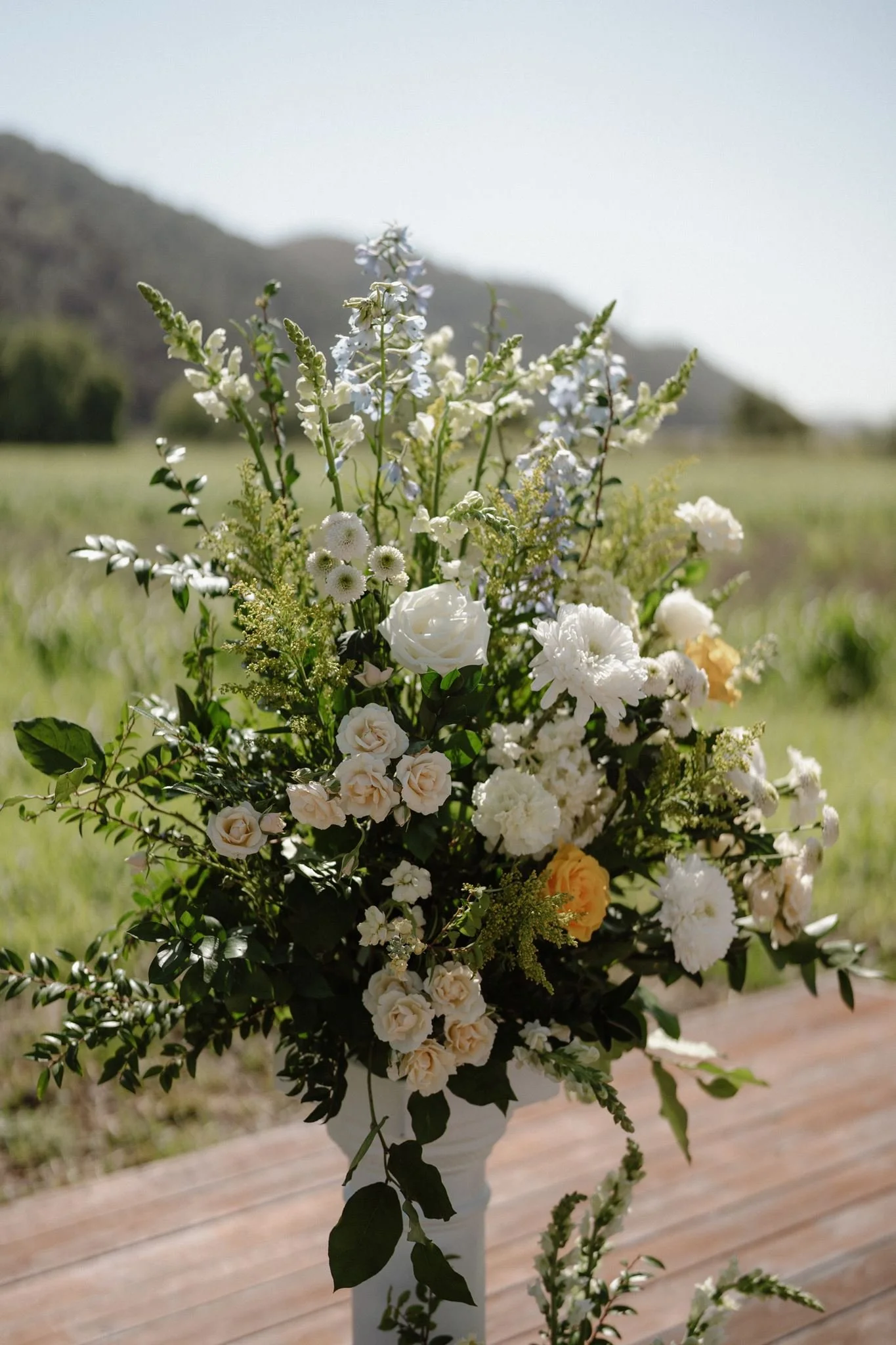 Spring floral pillar with cream yellow sage and pale blue flowers