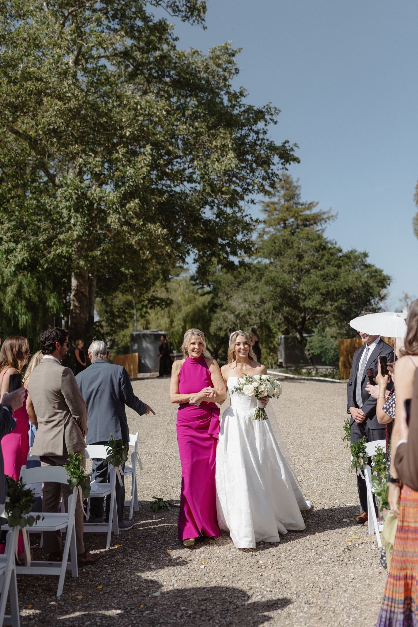 Hannah and her mother walking down the aisle at a Meadow wedding