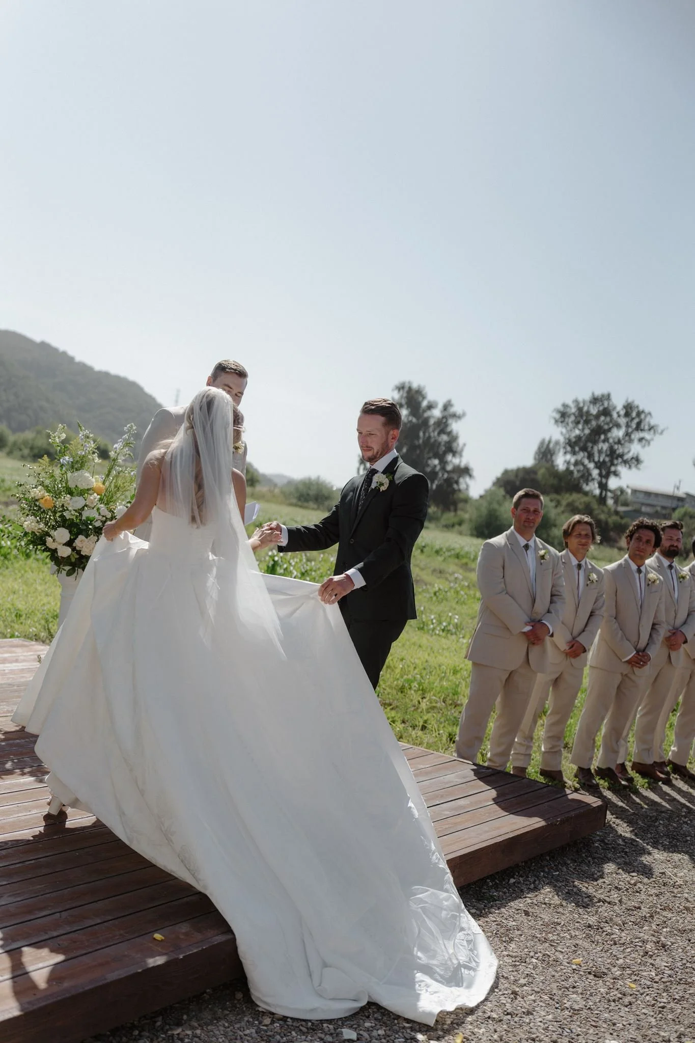 Connor helping Hannah onto the Meadow ceremony platform at Tar Creek Ranch