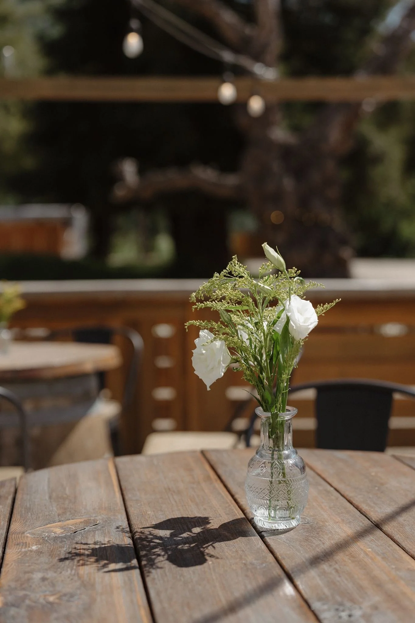 White spring flowers in a bud vase during Garden cocktail hour
