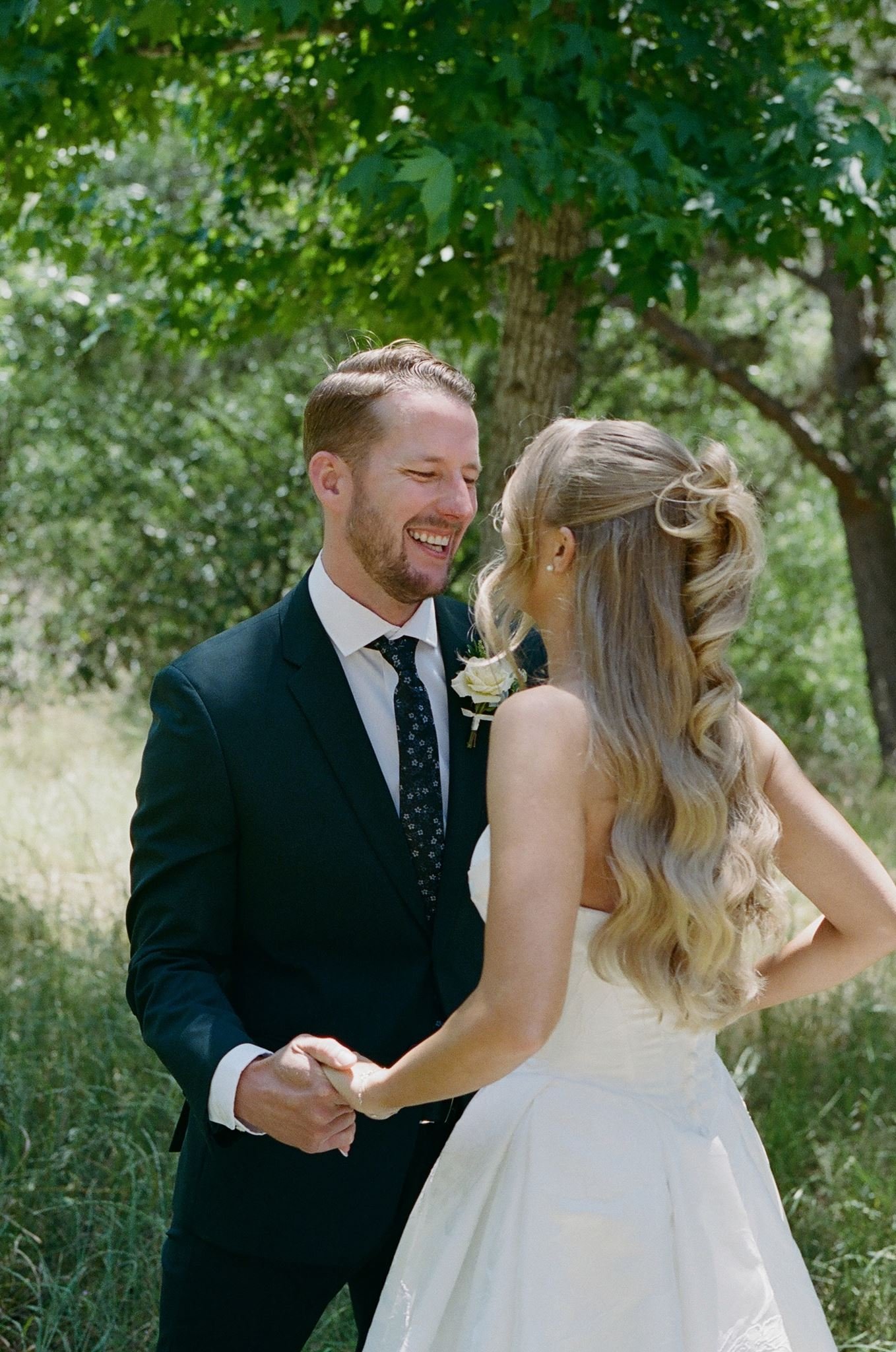 Hannah and Connor laughing together during spring wedding portraits