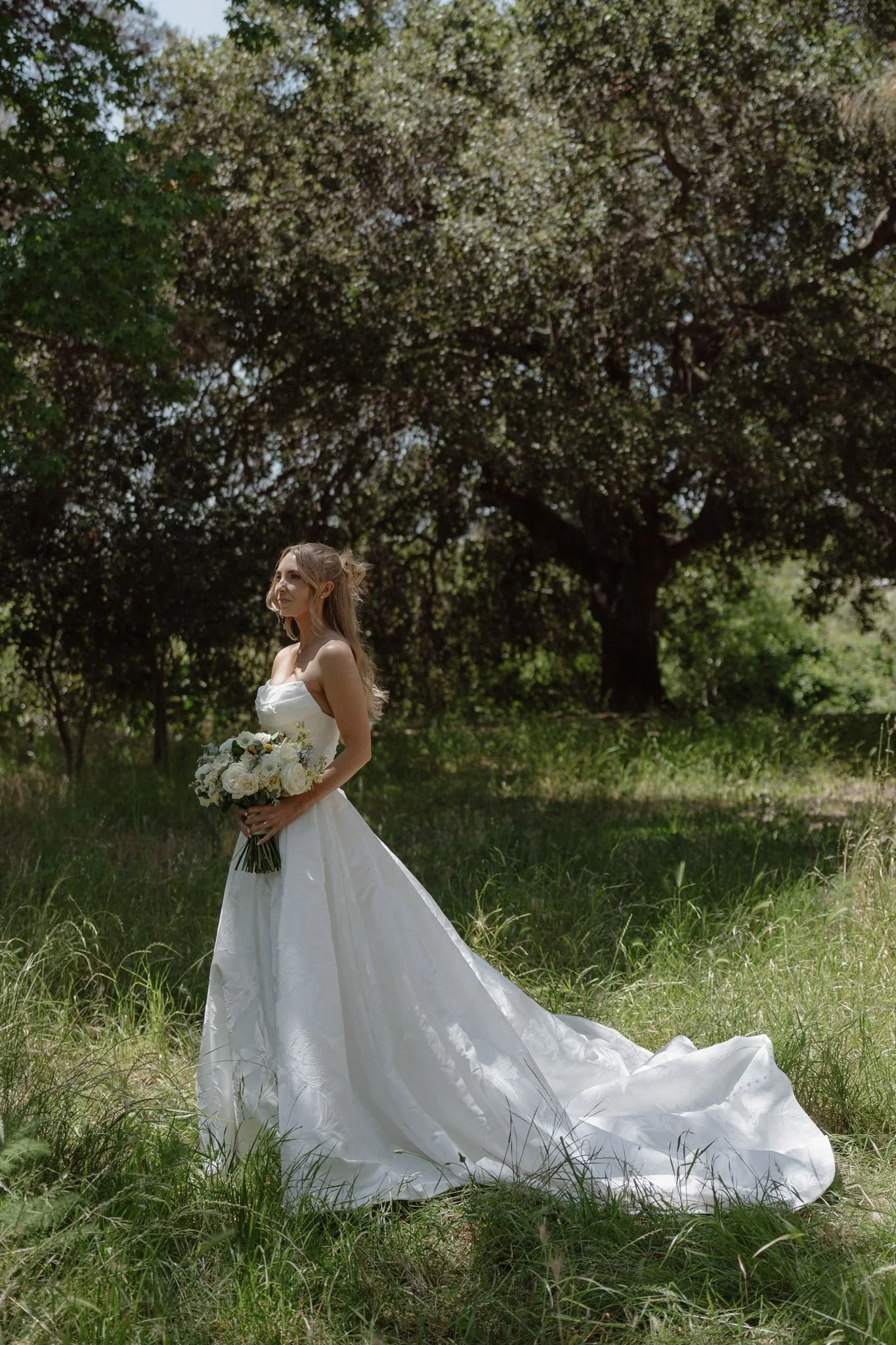 Hannah's bridal portrait in the green spring landscape at Tar Creek Ranch