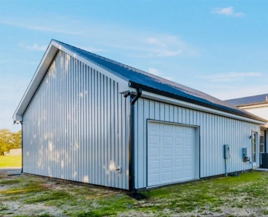 Finished detached garage with metal siding and standing-seam roof, built by Bottom Line Renovations in Charlotte, NC