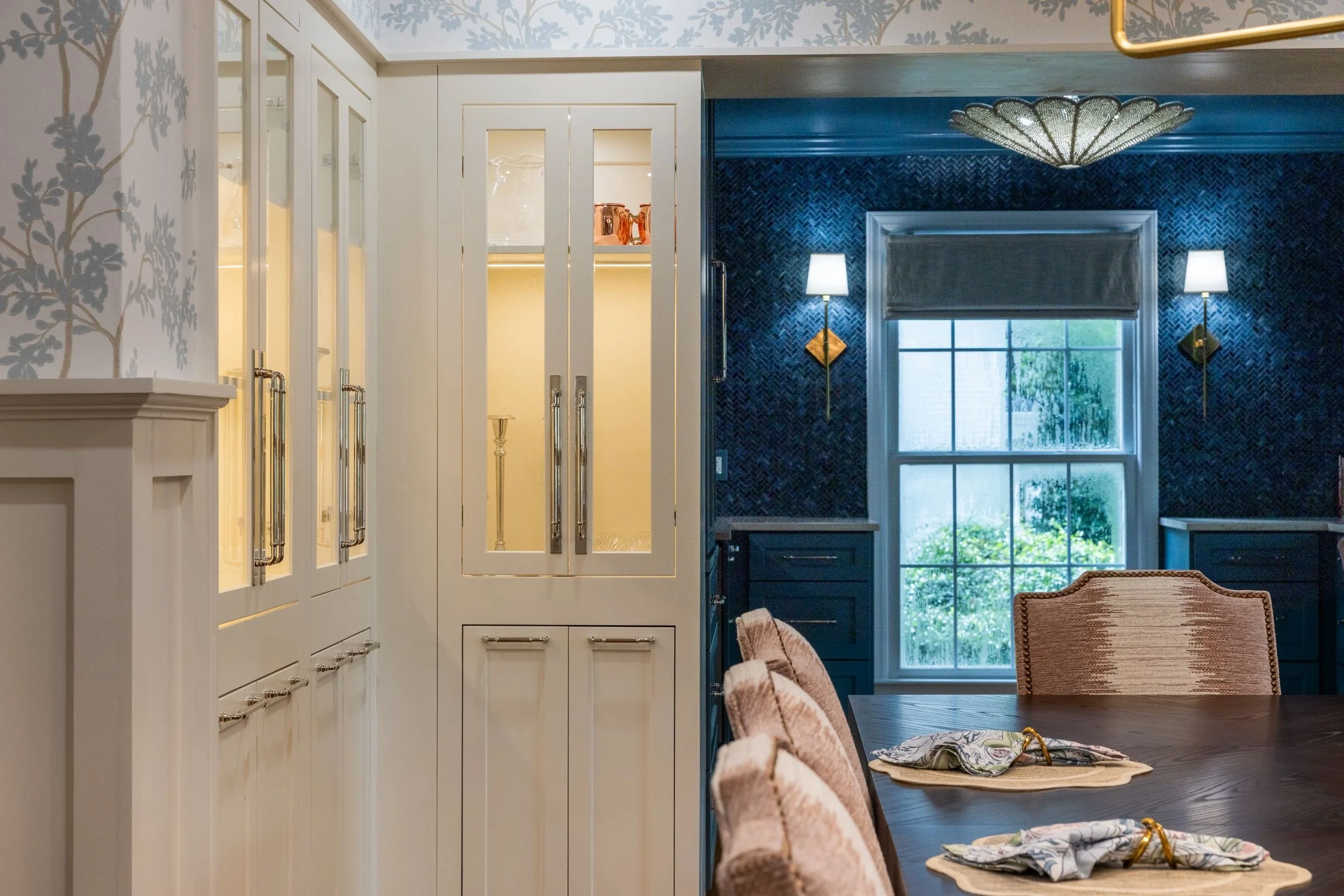 View from the dining room into a lacquered blue butler's pantry, showing a whole-home renovation in Charlotte, NC