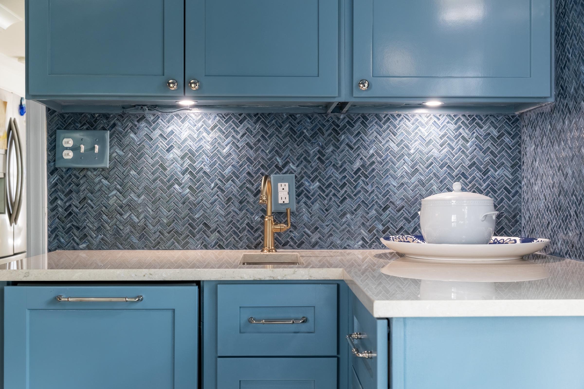 Blue mosaic tile backsplash, quartz countertop, and brass faucet in a custom butler's pantry in Charlotte, NC
