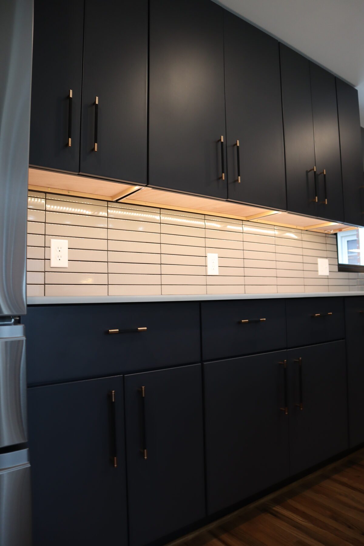 Close-up of custom cabinetry and brass hardware from a Charlotte, NC kitchen renovation