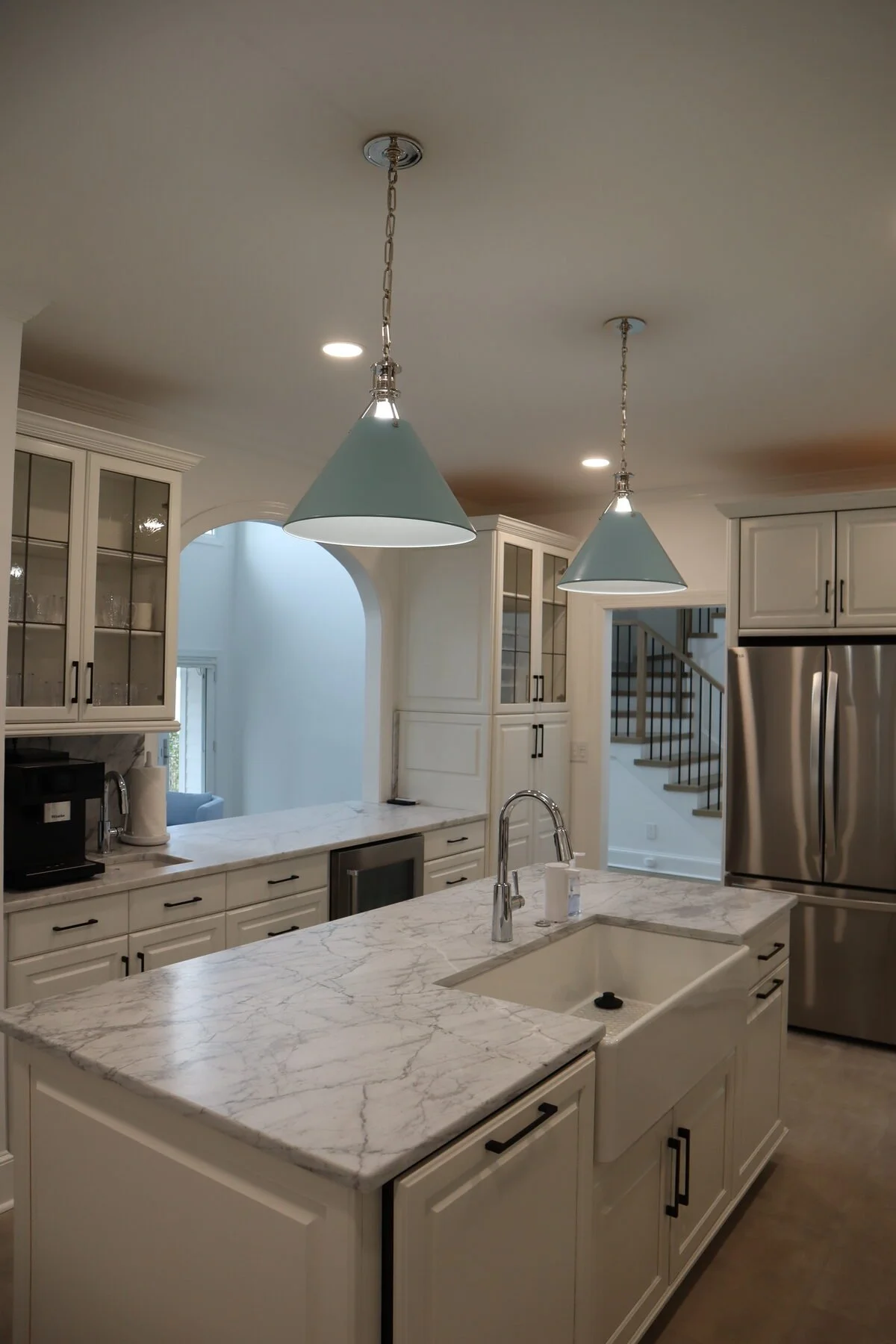 Classic white kitchen remodel in Charlotte, NC with marble countertops and farmhouse sink