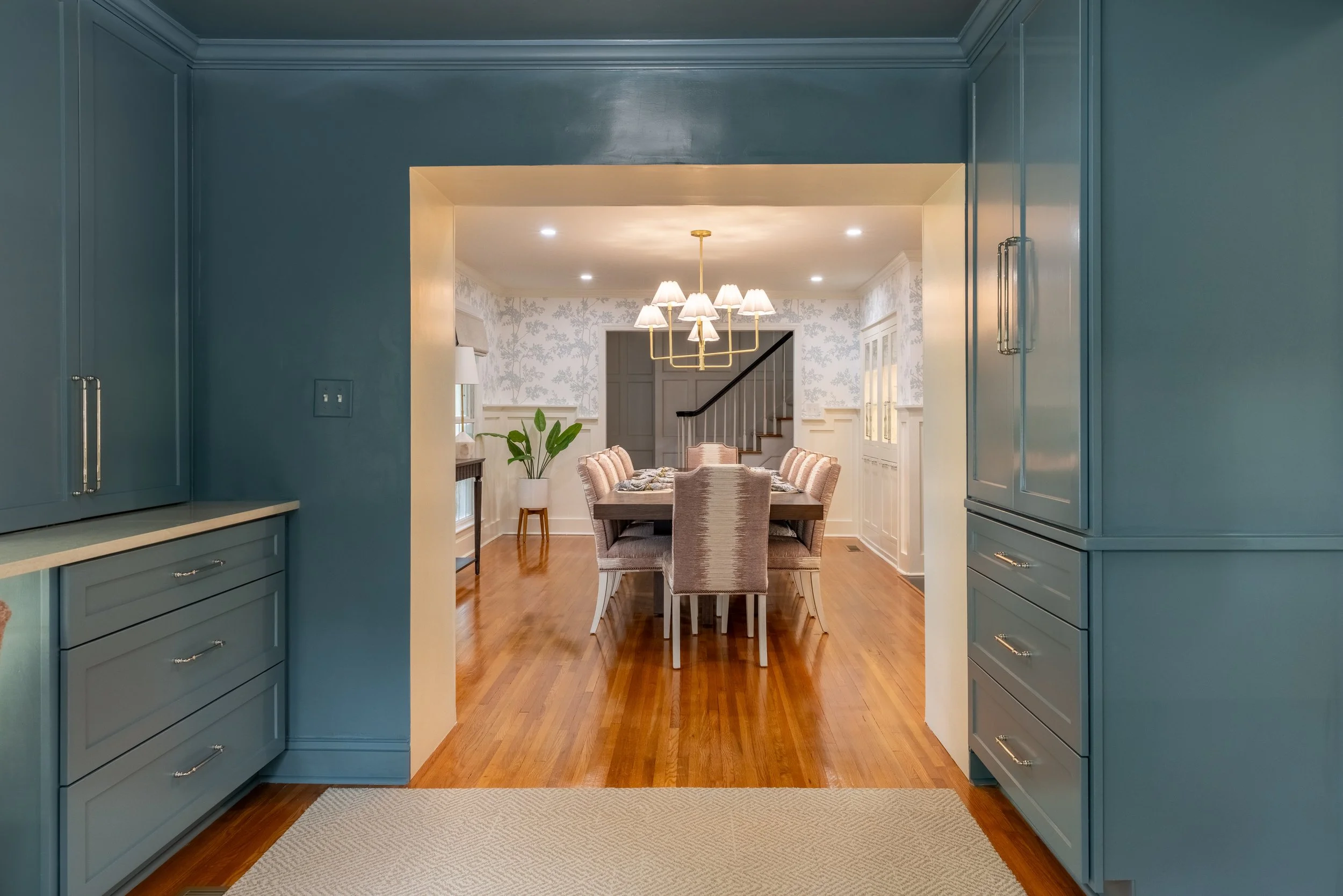 Elegant dining room with staircase and custom cabinetry from a Charlotte, NC whole-home renovation