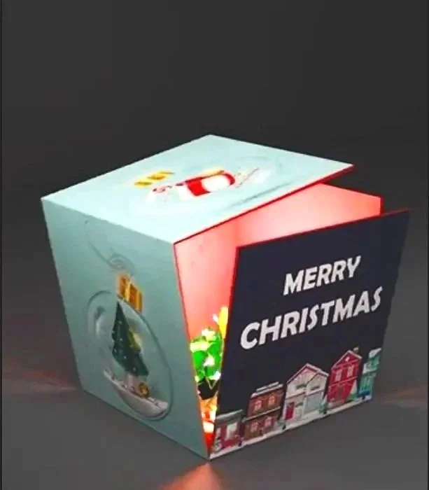A festive Christmas light cube decoration with a 'Merry Christmas' message and holiday-themed illustrations.