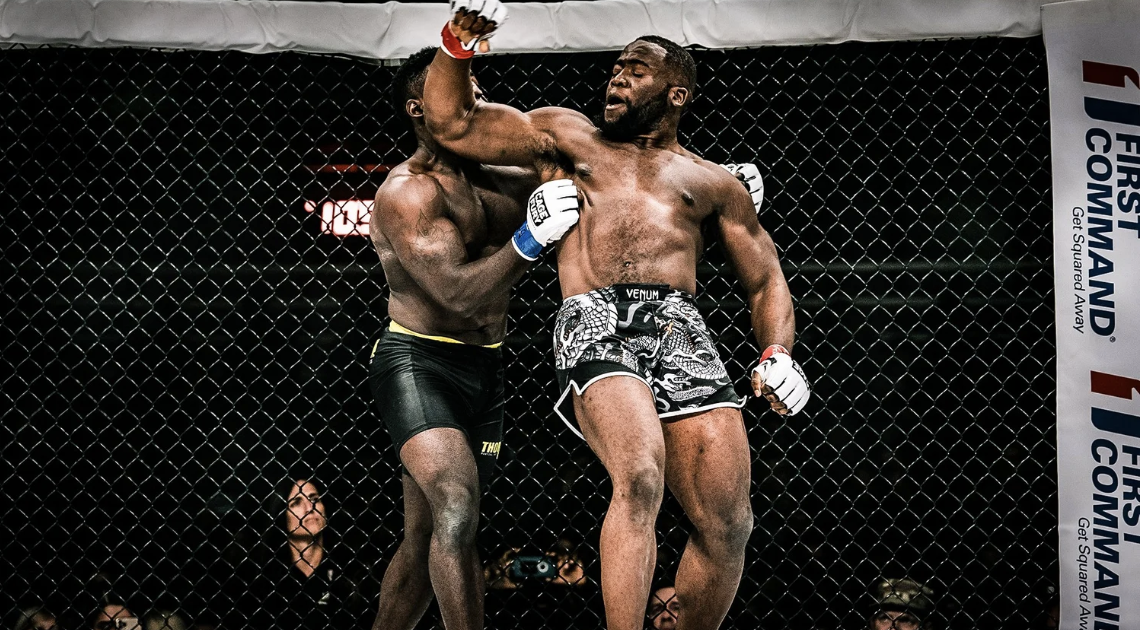 Nchukwi vs. Knight inside a cage, one landing a punch on the other.