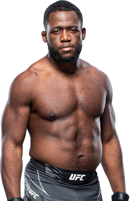 Tafon "Da Don" Nchukwi standing shirtless in UFC fight shorts, looking serious, with a confident stance.