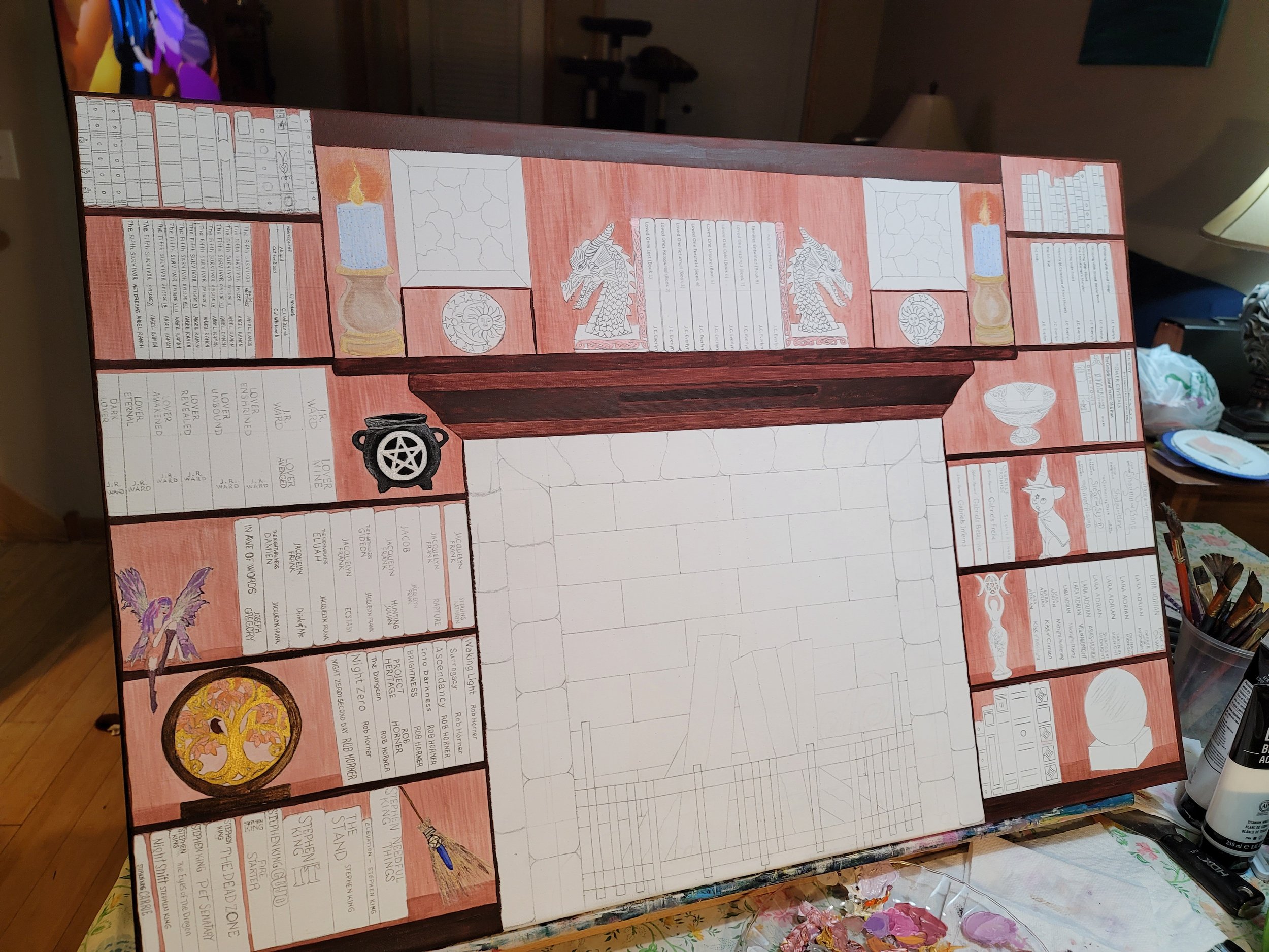 Colorful hand-painted bookshleves with various sections, illustrations of dragons, a pentagram, a fairy, a cat, a crystal ball, and other decorative elements, with a large uncolored central area for a fire place.