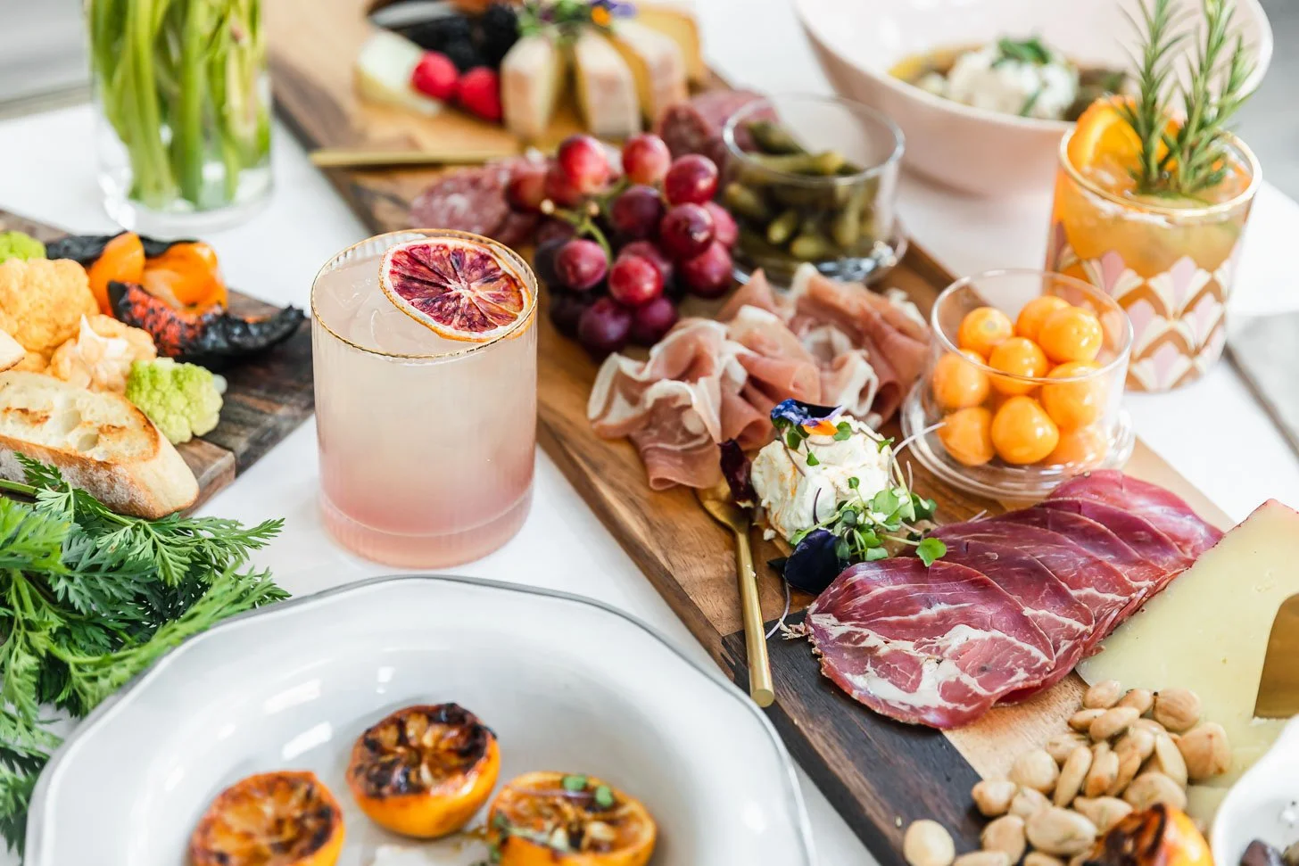 Beautiful food photography of charcuterie board with cured meats, cheeses, grapes, nuts, and sliced bread taken by muse group marketing for event photography and public relations in reno.