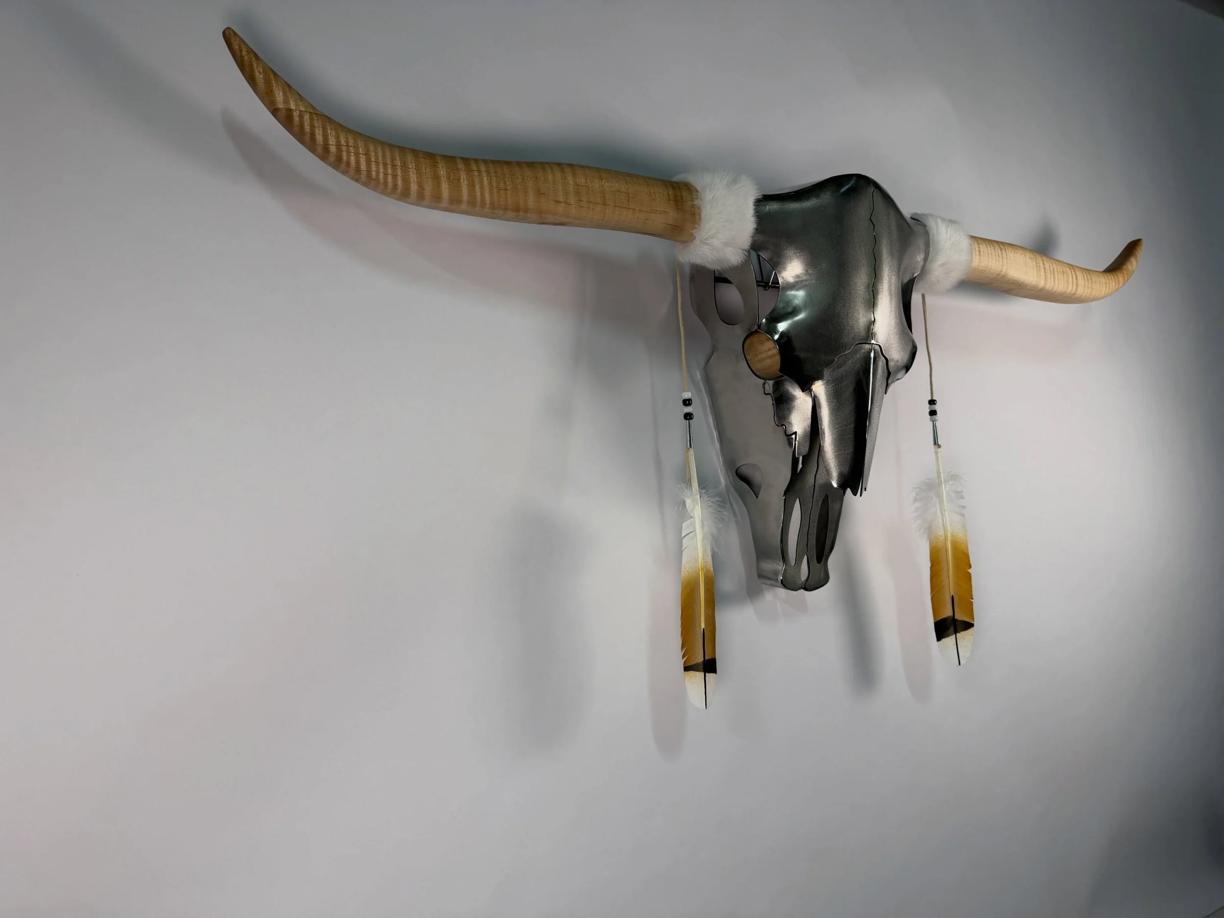 Dreamer reimagined in hand formed cold forged stainless steel and handmade horns from curly maple.

Each piece is handcrafted with intention, blending traditional motifs with contemporary vision.

Whether adorned with tribal patterns, feathers, beads
