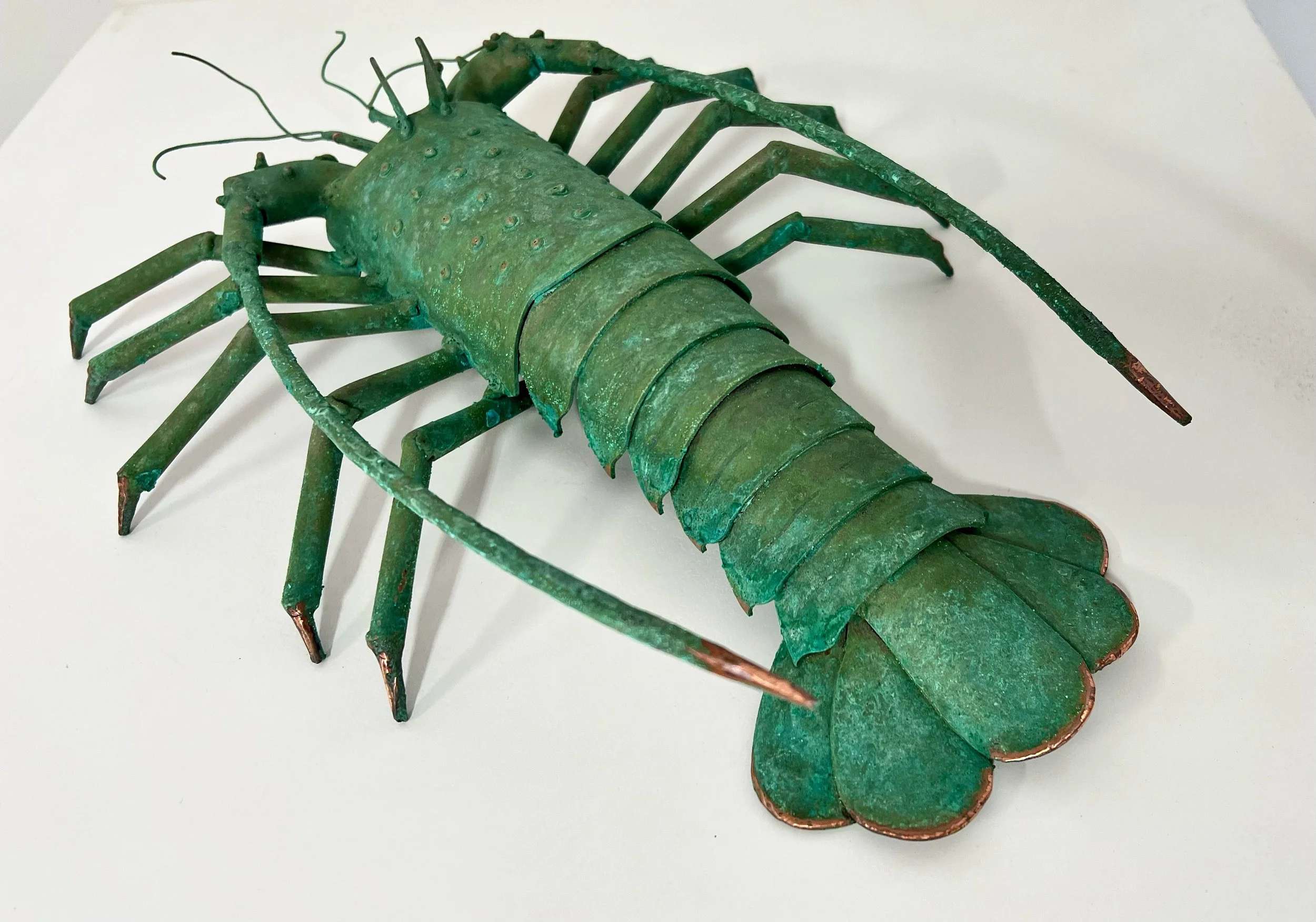 Copper w/ patina. Sold