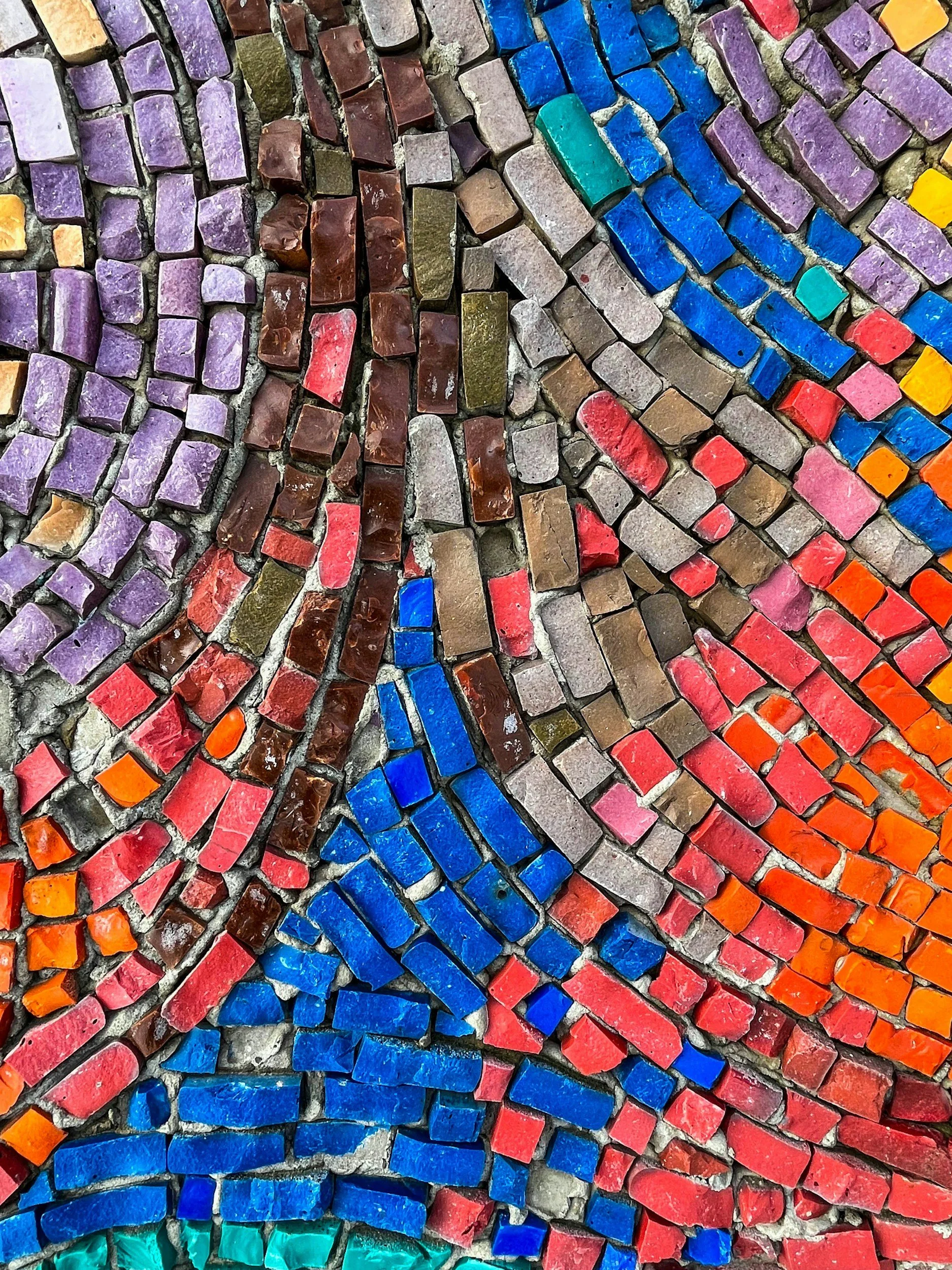 Hand-painted stone tiles representing the unique, individualized virtual therapy services offered to adults struggling with identity shifts or life transitions in California.