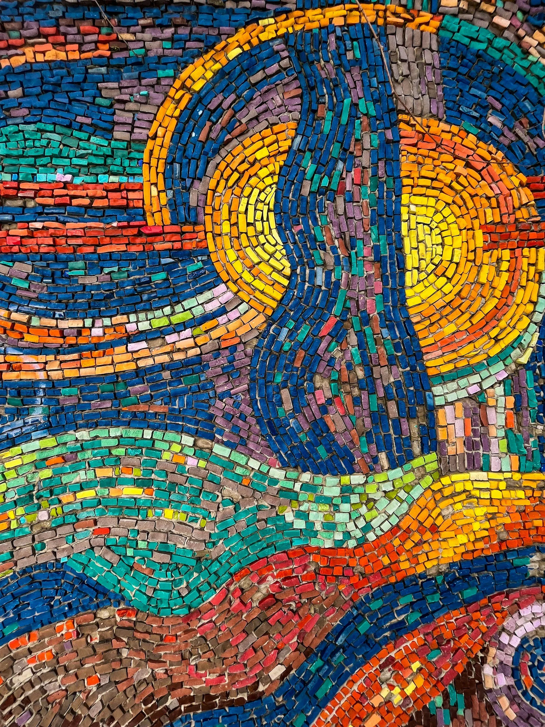 Blue, green, and gold tiles in a wave pattern symbolizing the fluid, collaborative psychotherapy process for adults across California.