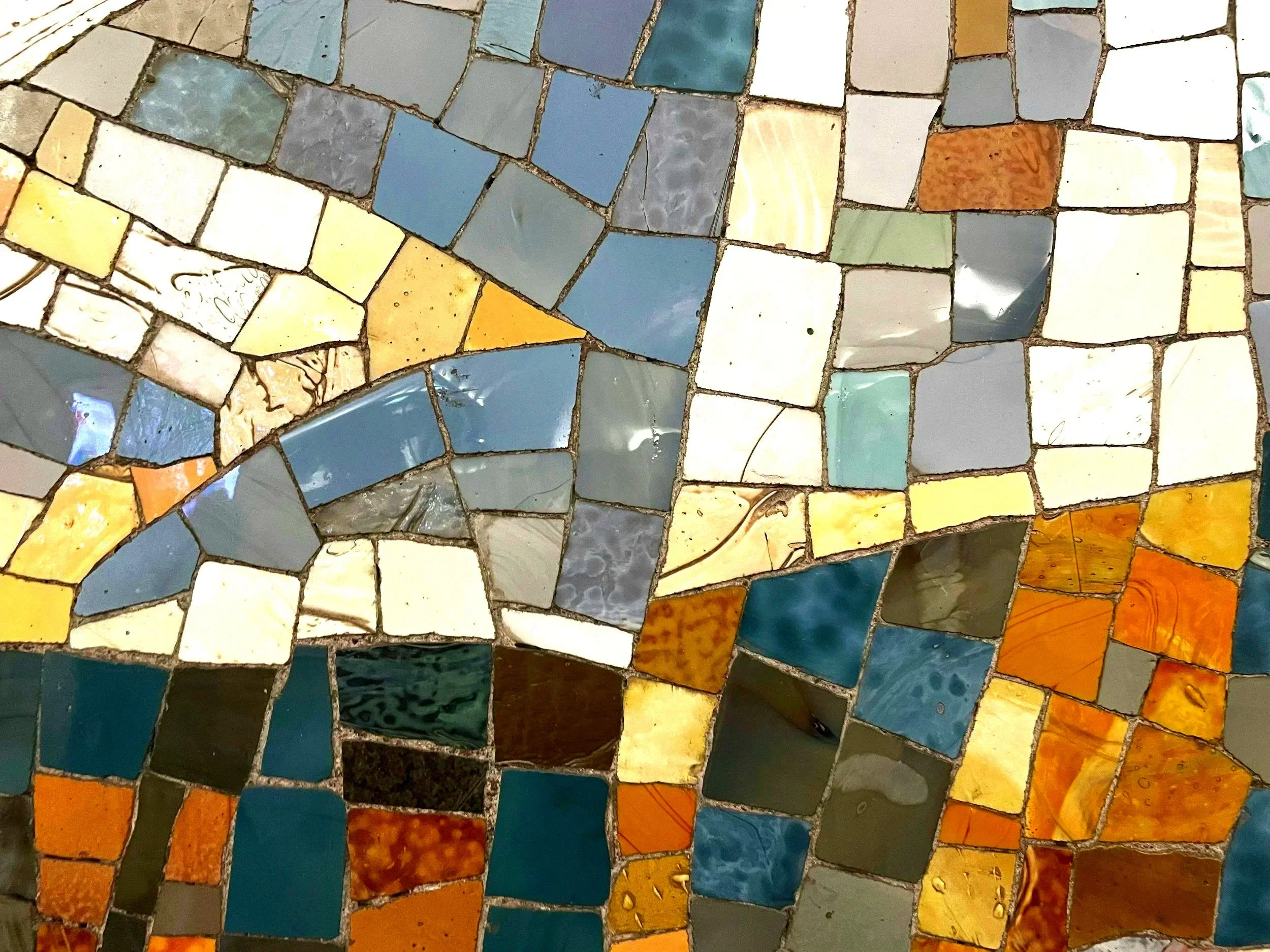 Earth-toned stone tiles representing the layered process of healing developmental and attachment trauma in virtual California psychotherapy.