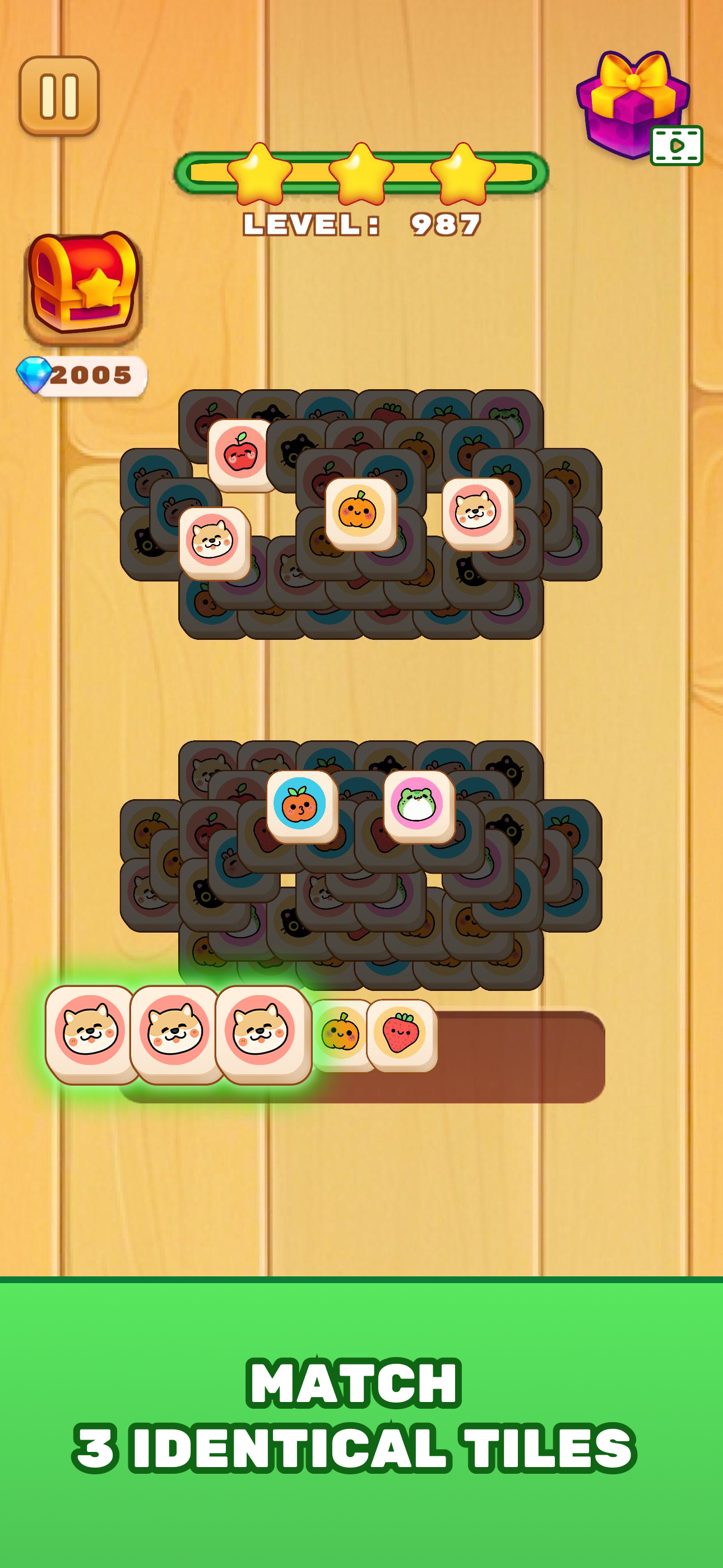 A match-3 puzzle game screen showing tiles with animal and fruit icons on a wooden background, with text indicating the goal to match three identical tiles, and a green banner at the bottom.
