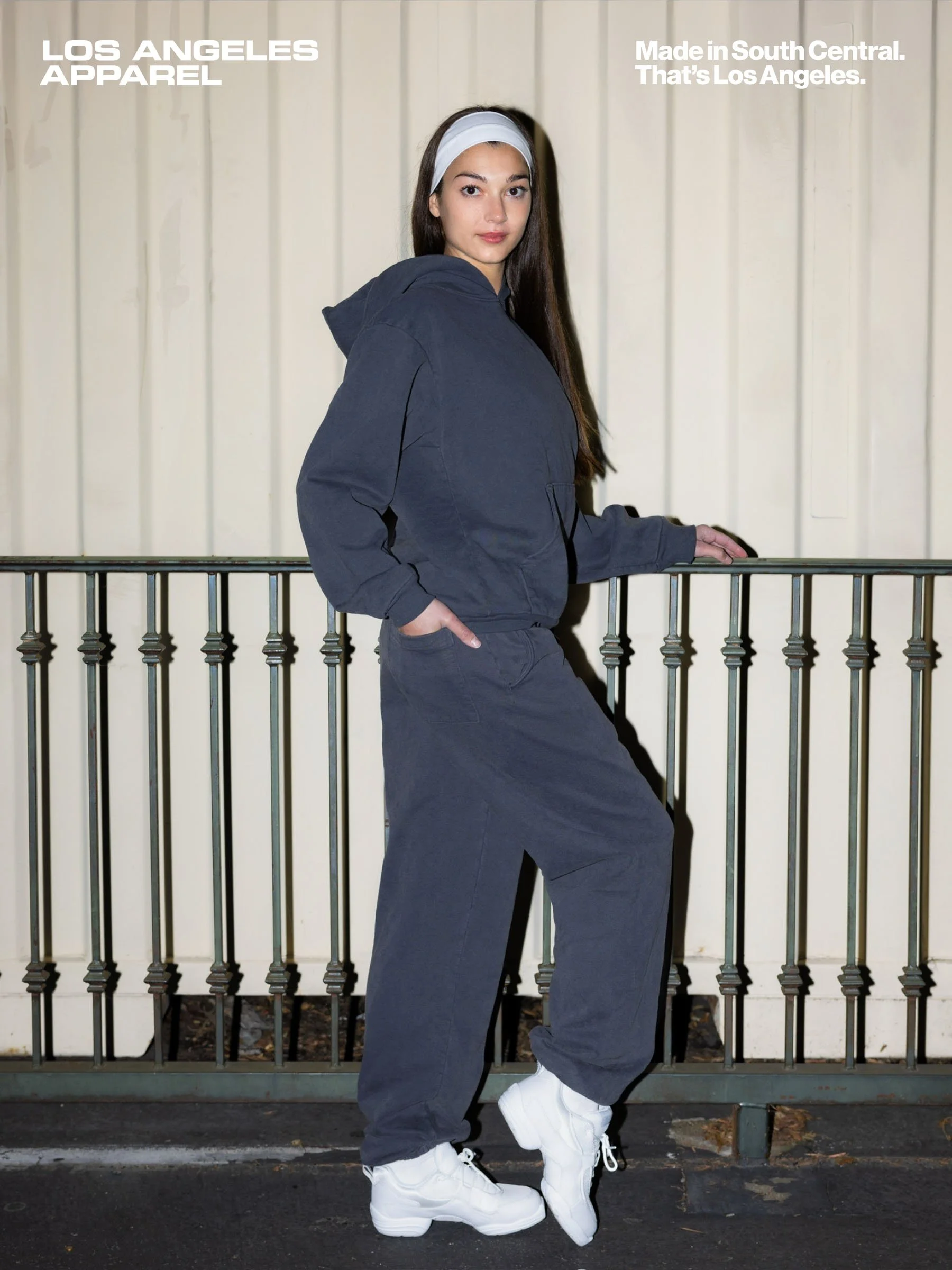 A flash-lit photograph of a young woman in a fleece sweatsuit.