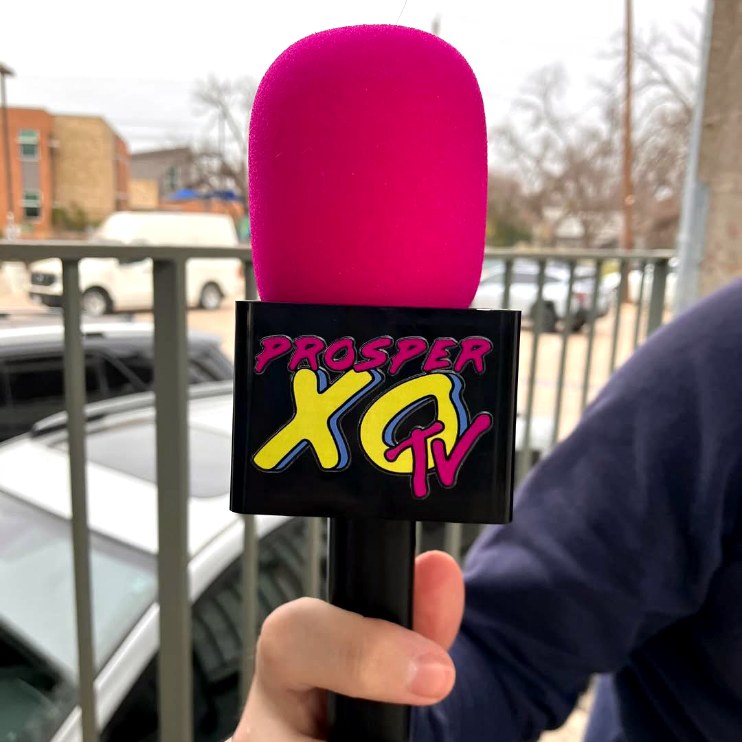 A photograph of a mic with a uv dtf decal on the side.