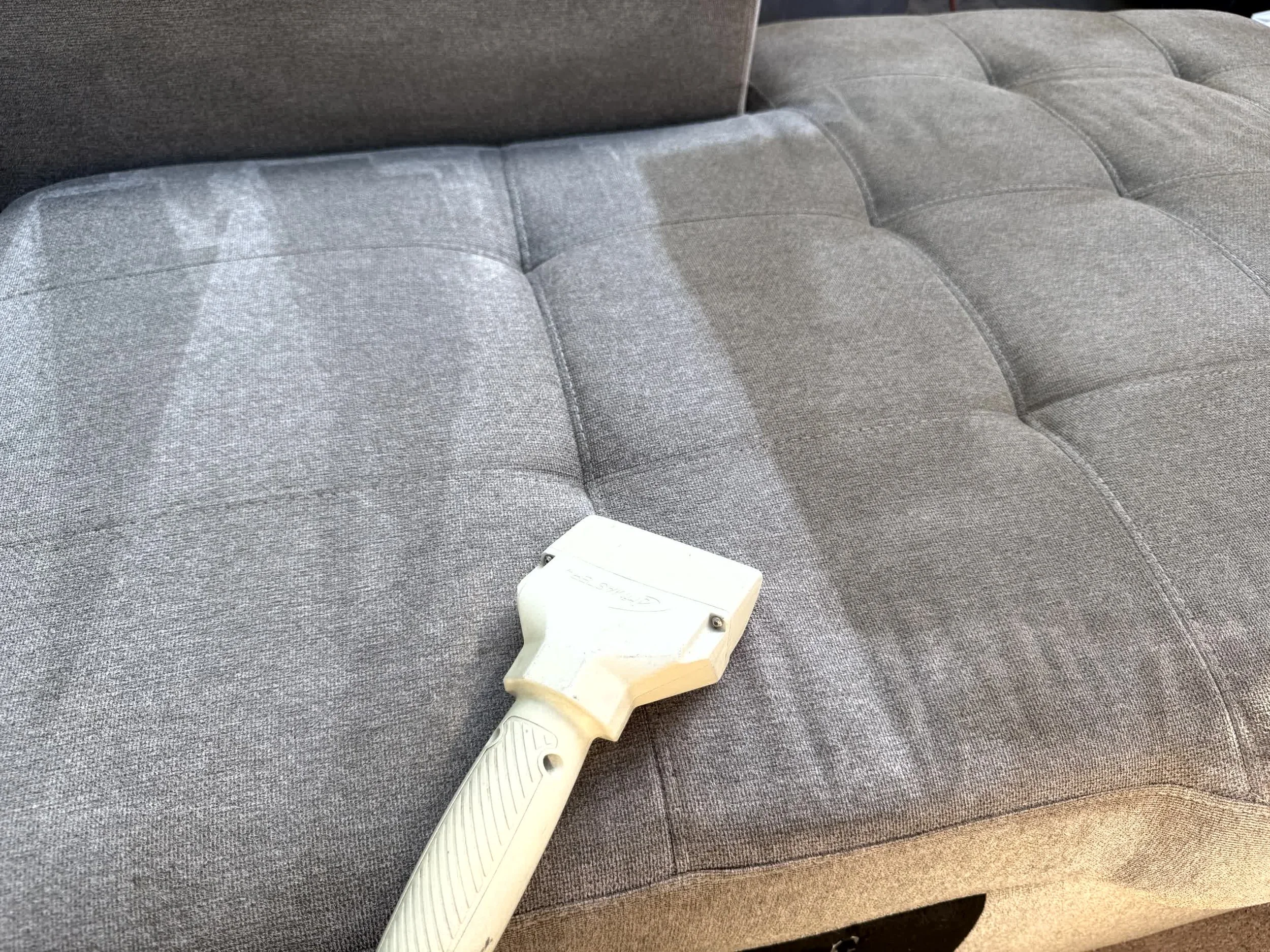 During photo of a dirty sectional couch.