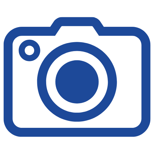 Icon of a camera with a large lens and a small flash, in blue outline.