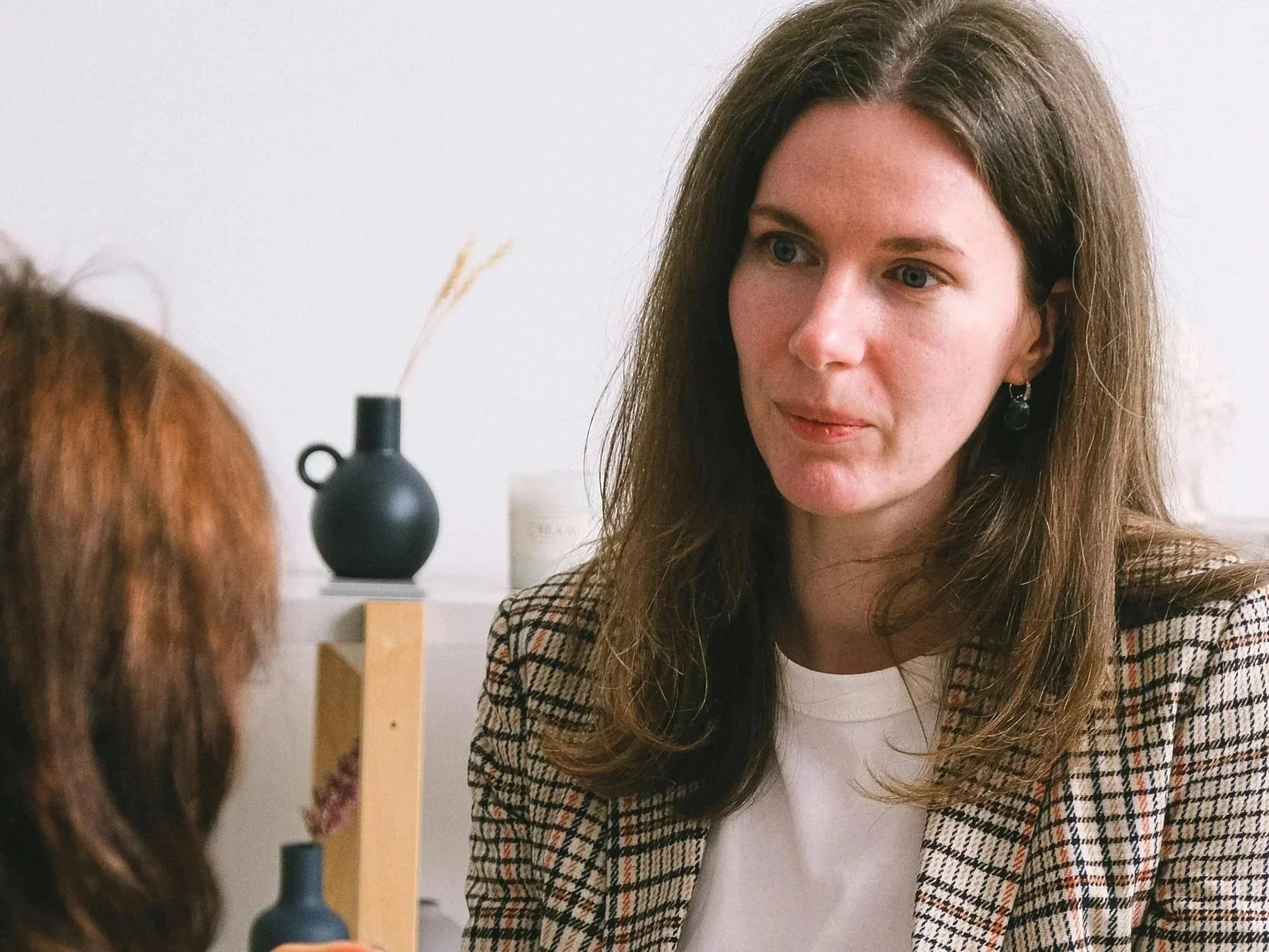 Wellness clinic owner discussing search visibility and patient acquisition strategy with consultant