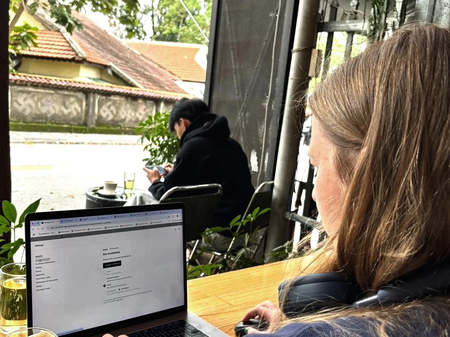 SEO Shalyn optimizing a therapists Squarespace website while working in Vietnam at a coffee shop
