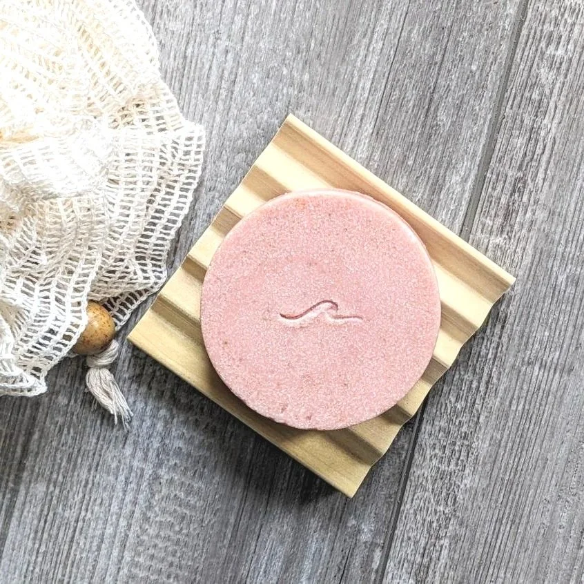 Shore Honey Oatmeal milk & honey sea salt soap, pink round soap on natural wood soap dish.