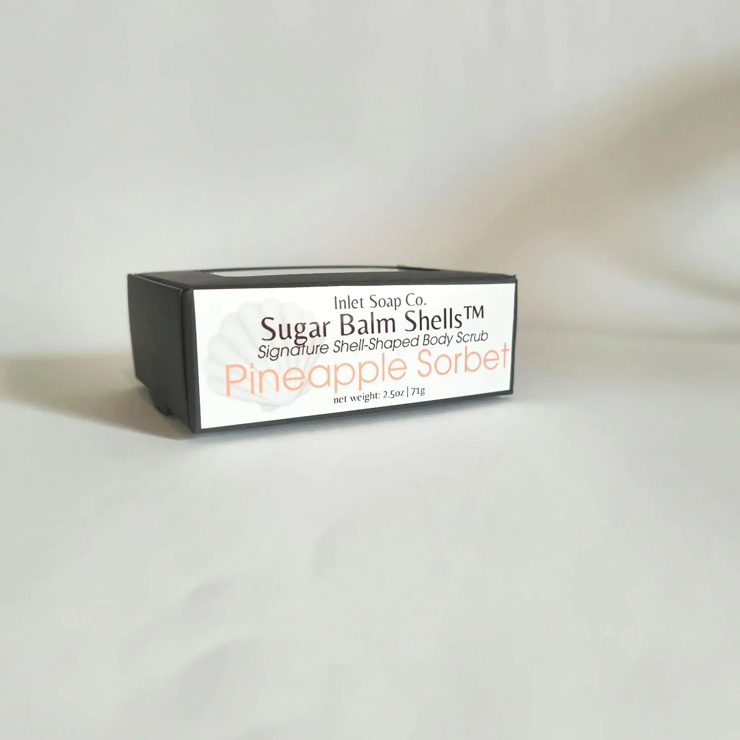 Black box with Inlet Soap Co. Pineapple Sorbet Sugar Balm Shells label on plain white background.