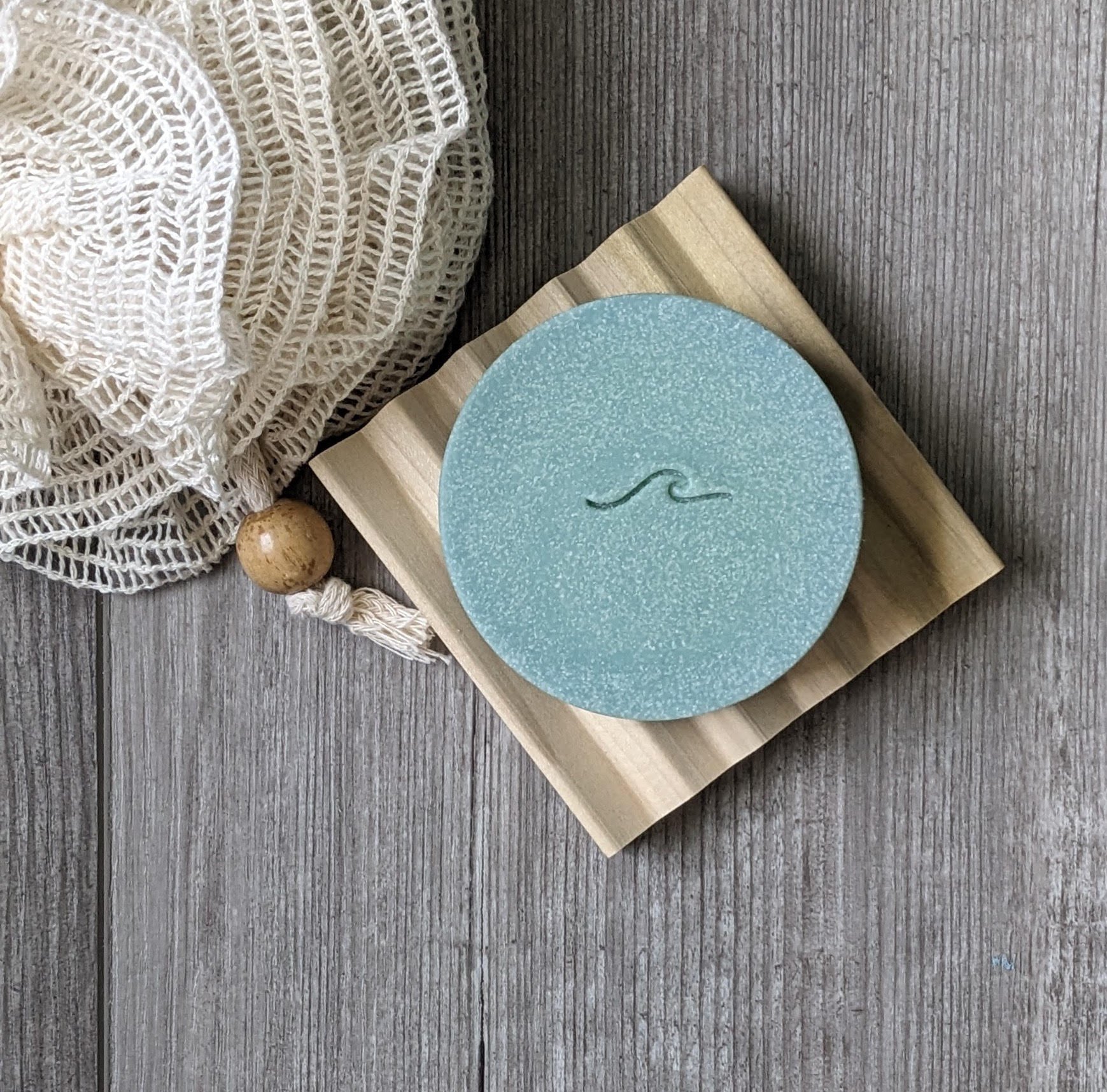 Round sea salt soap bar with wave stamp.