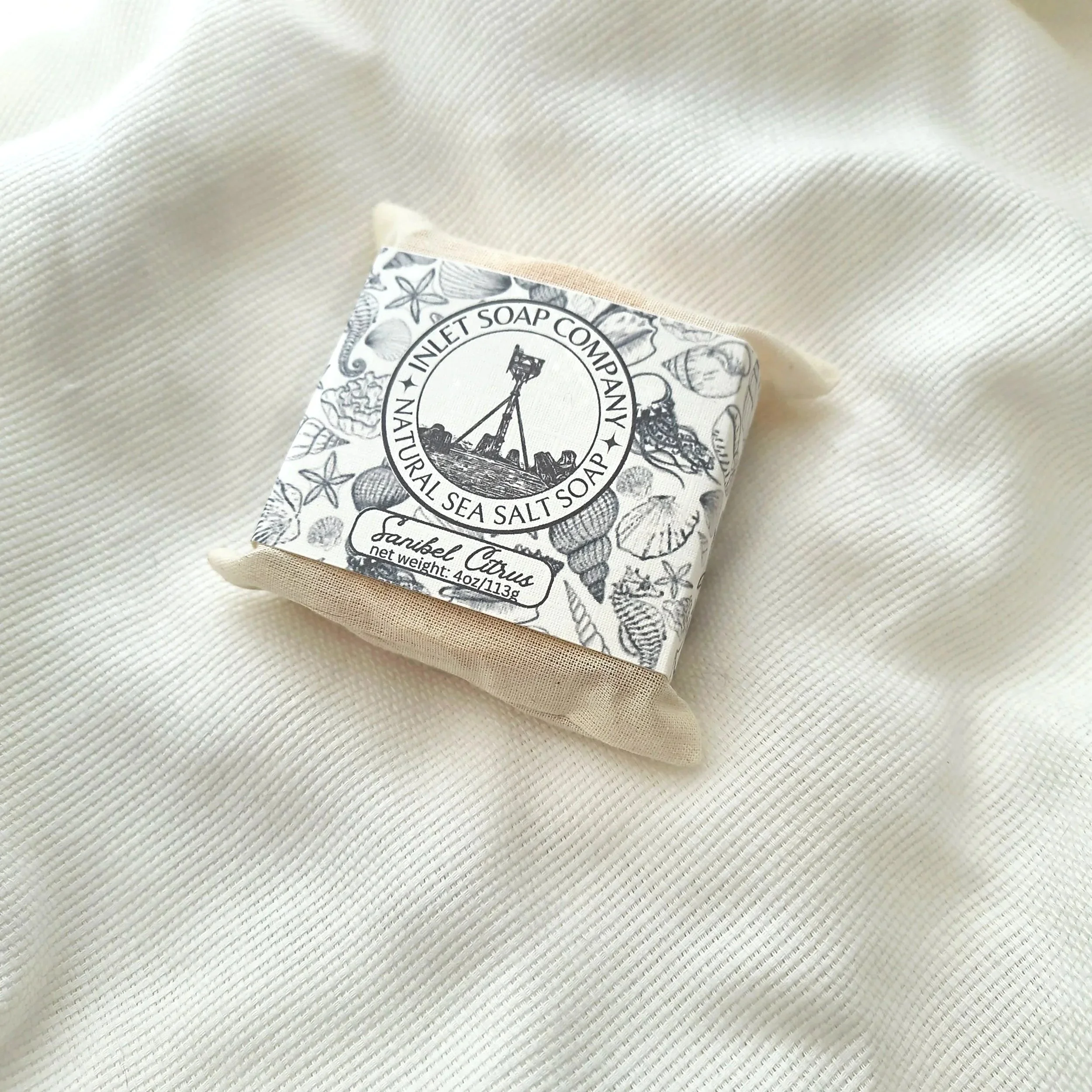 Inlet Soap Co. sea salt soap bar in a reusable muslin bag, recyclable cardstock sleeve with logo.