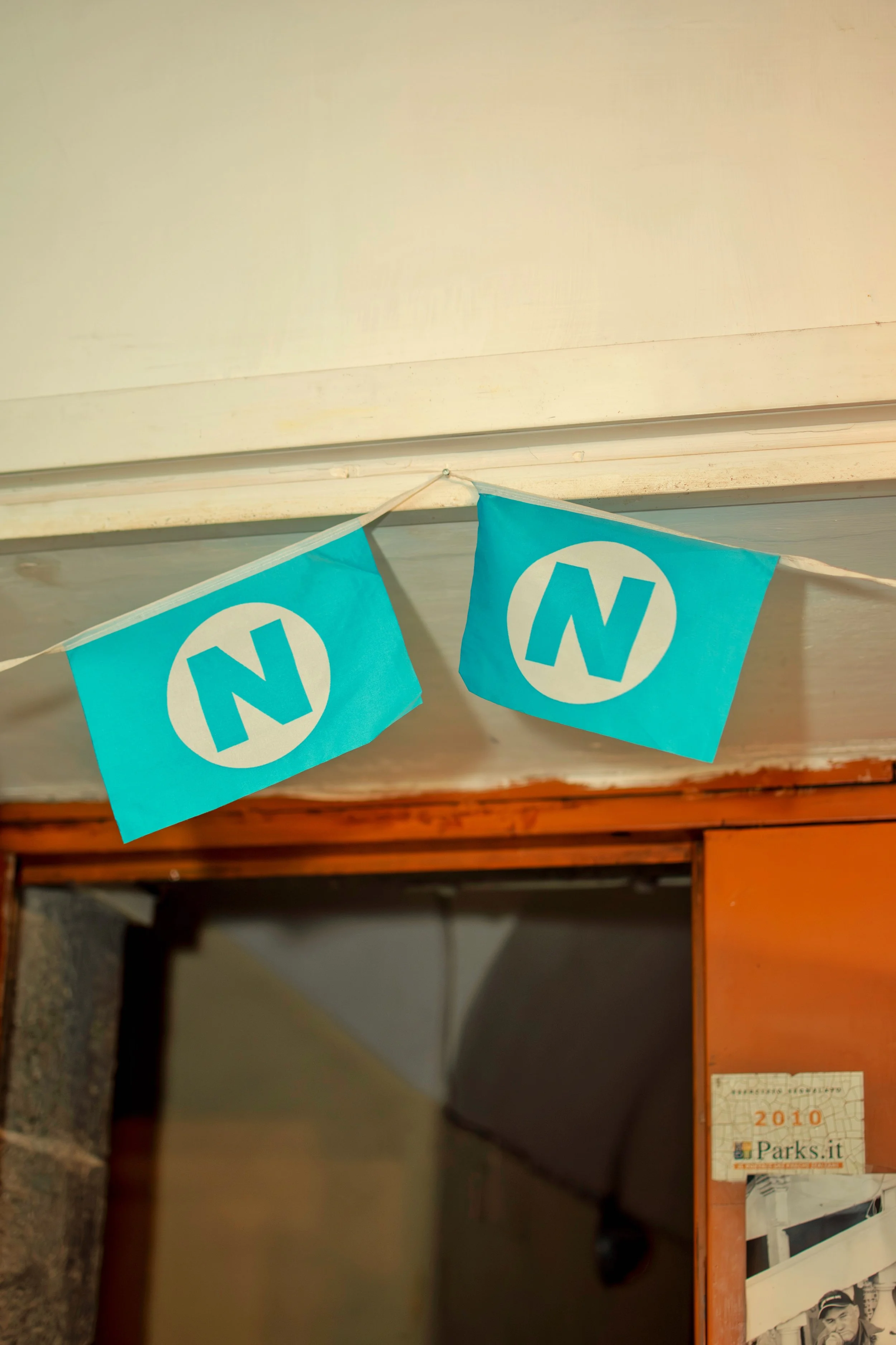 Blue pennant flags with a white circle and a blue letter 'N' hanging from the ceiling.