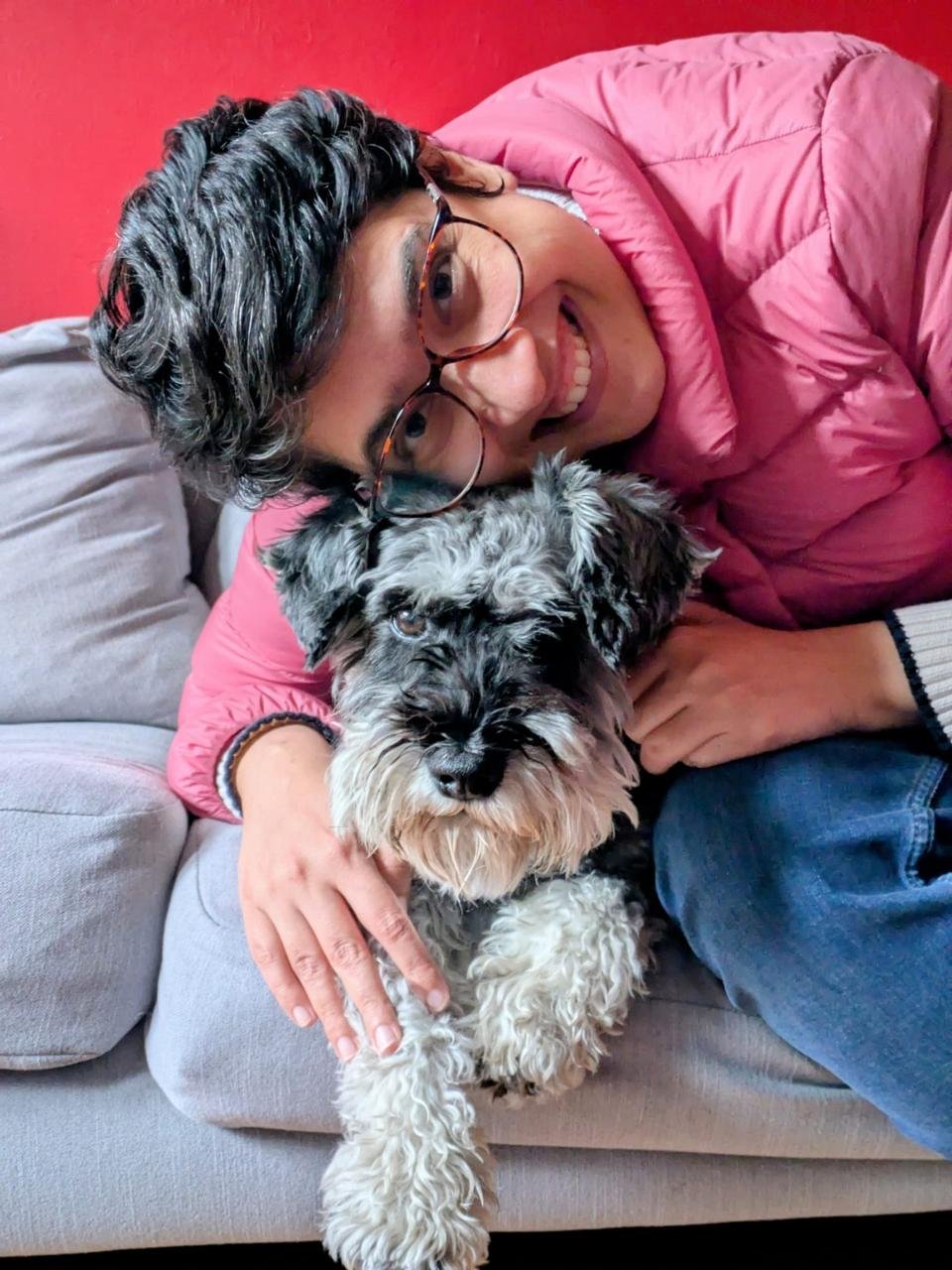 Image shows Mansi hugging a dog