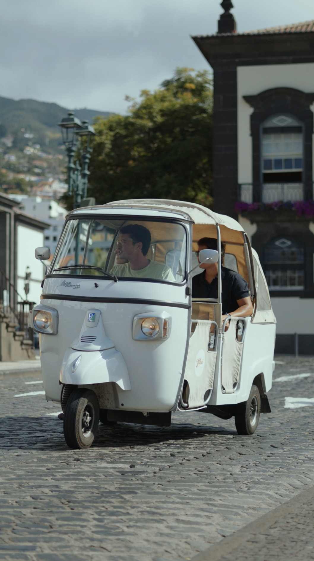 Three-wheeler tuk-tuk with two clients in Funchal city