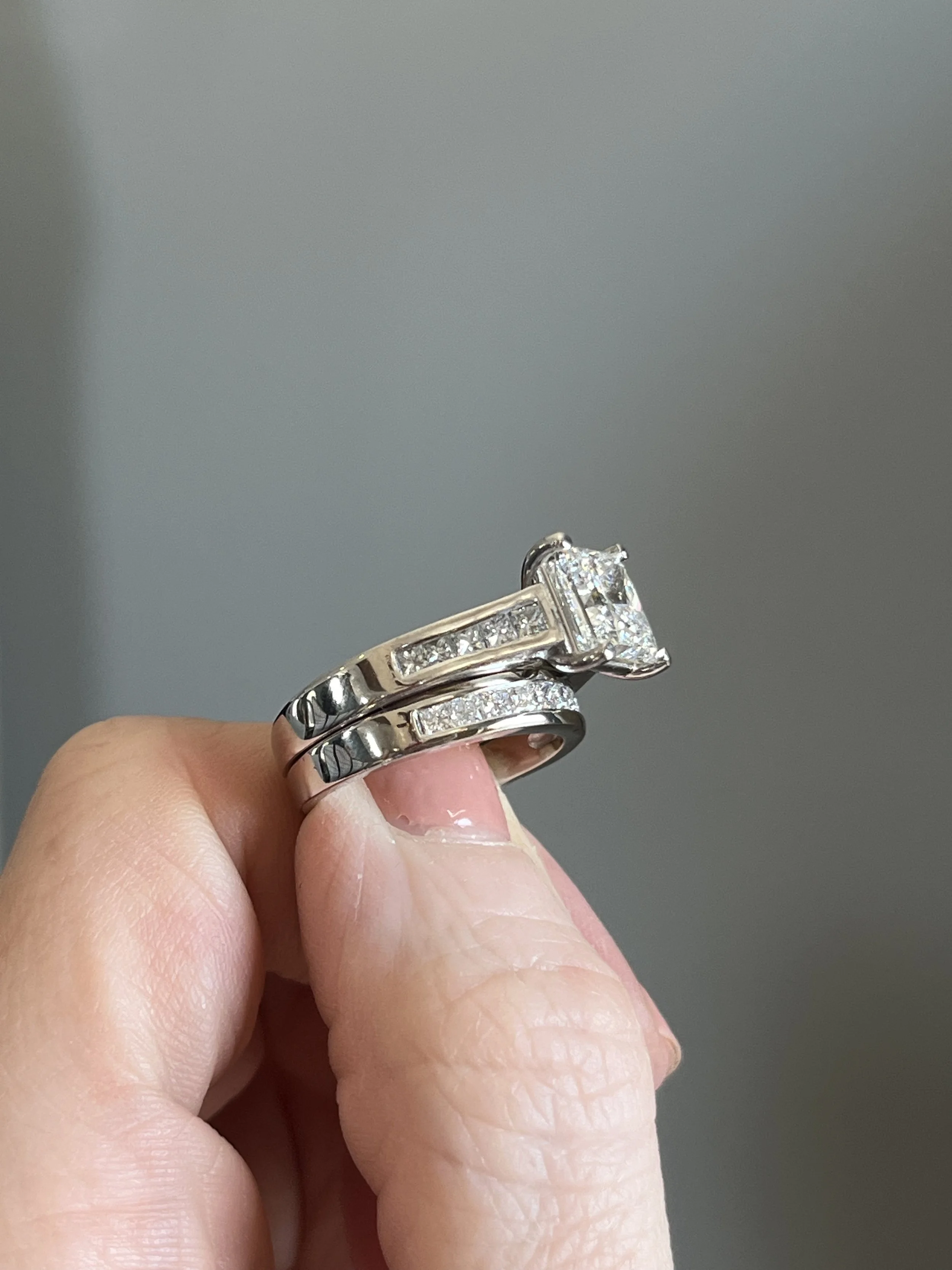 A custom wedding set created by TSC Jewelry. This square princess cut channel set engagement ring is complimented by a matching diamond wedding band