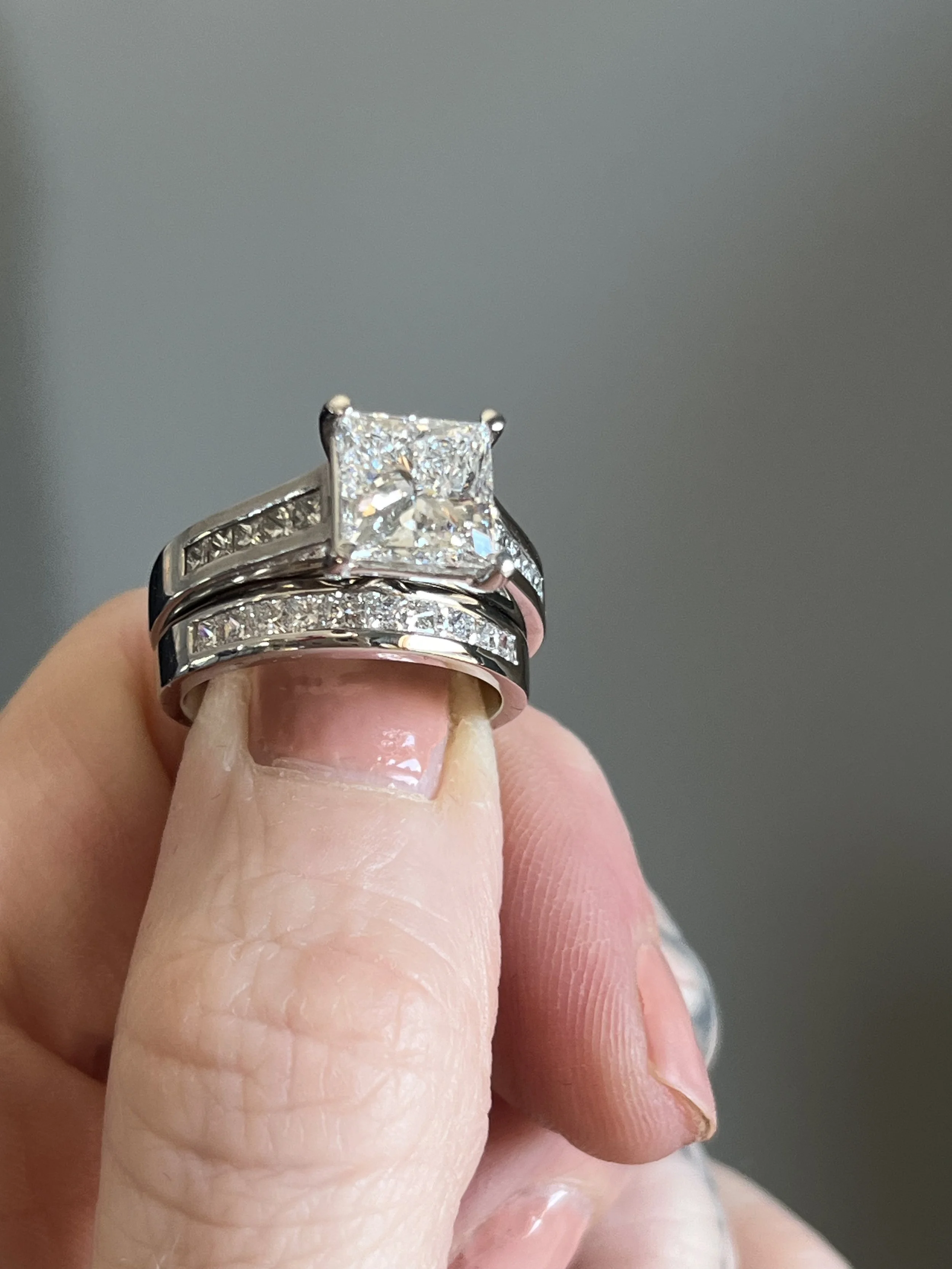 A custom wedding set created by TSC Jewelry. This square princess cut channel set engagement ring is complimented by a matching diamond wedding band