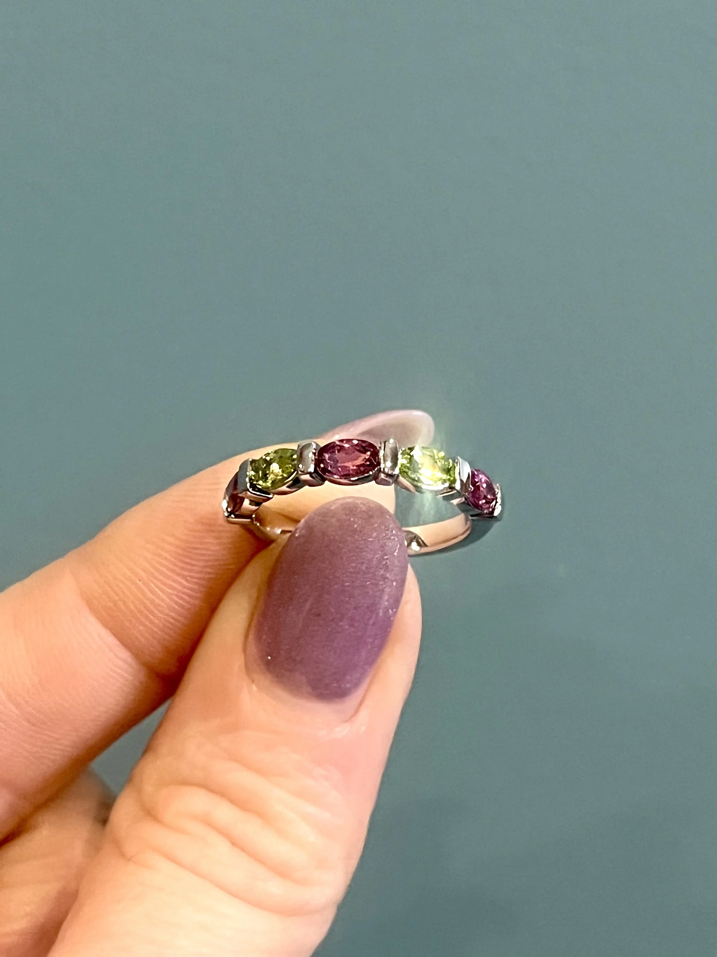 a birthstone mothers ring featuring peridot and tourmaline gemstones, custom made by TSC Jewelry