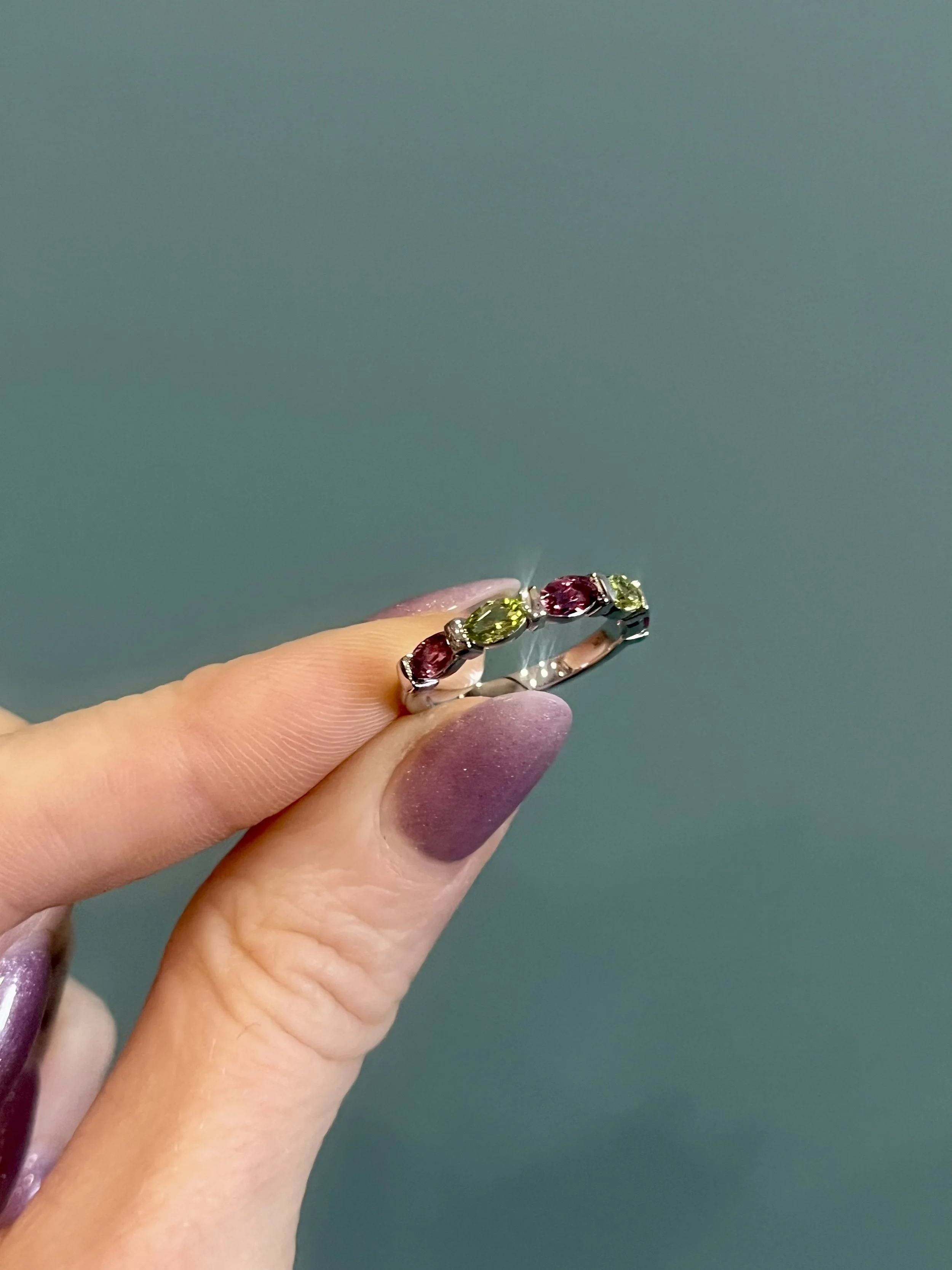 a birthstone mothers ring featuring peridot and tourmaline gemstones, custom made by TSC Jewelry