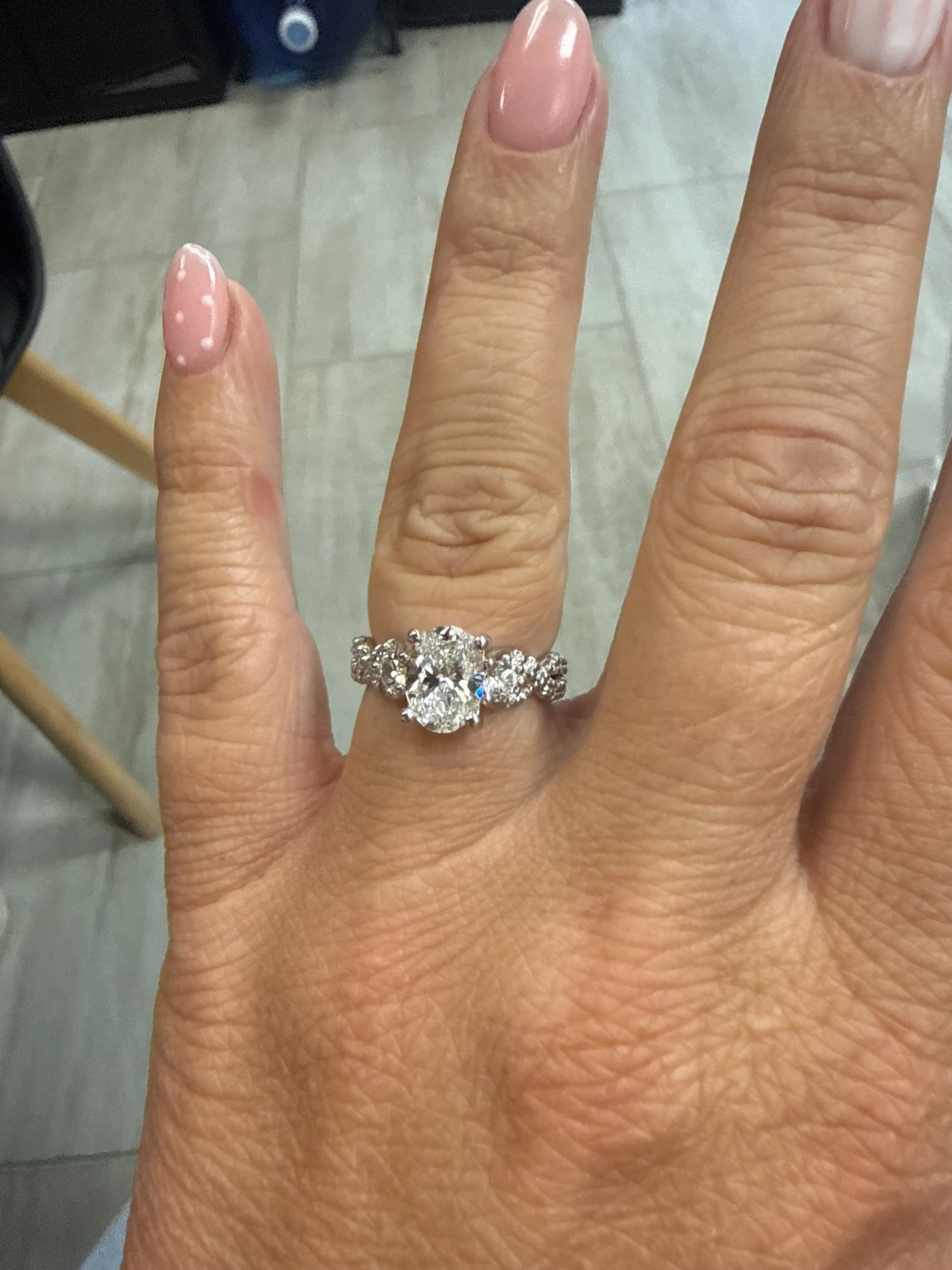 A close-up of a hand wearing a diamond ring custom made by TSC Jewelry