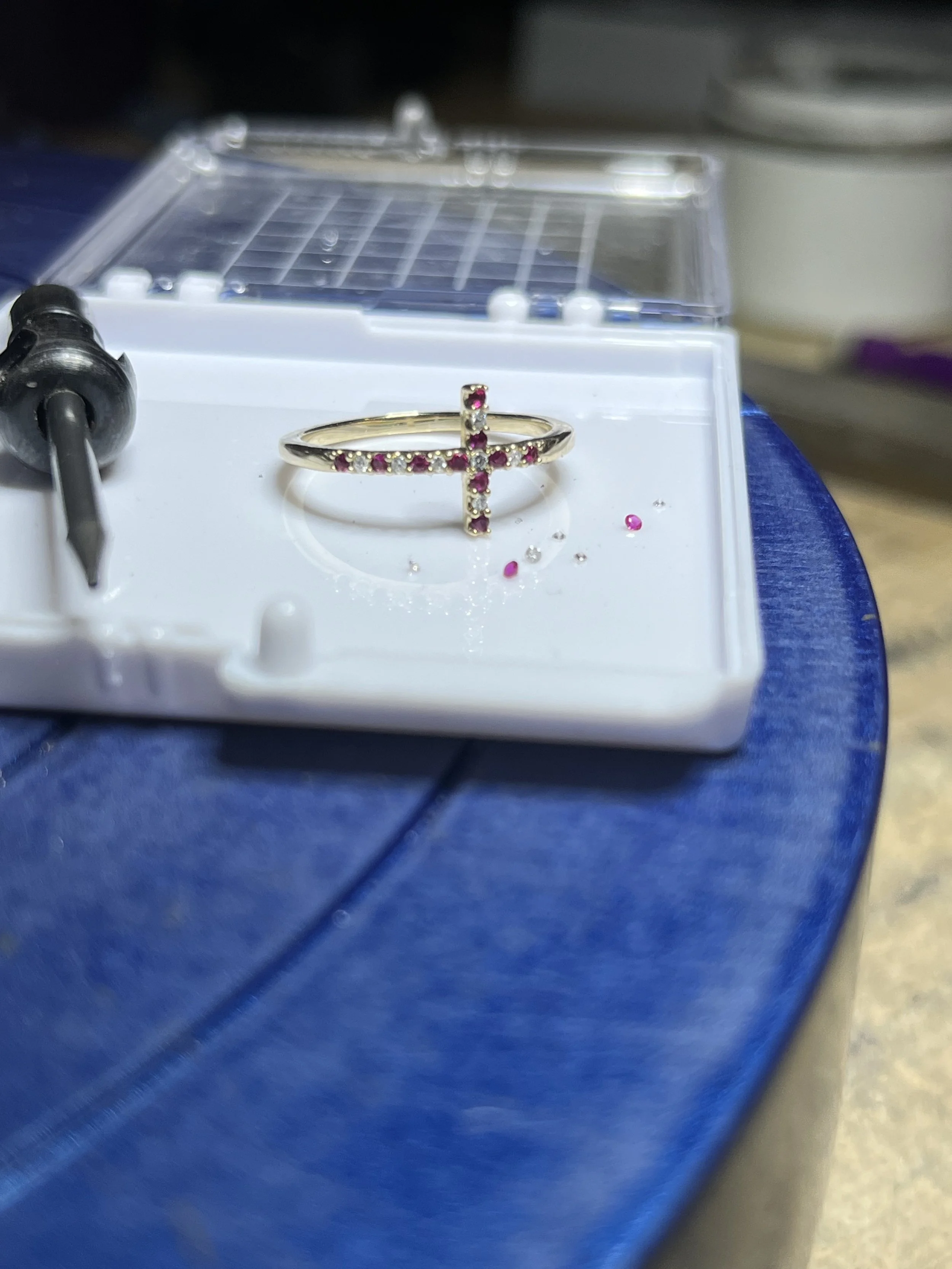 A work in progress photo of a custom cross ring by TSC Jewelry, featuring yellow gold with diamond and ruby gemstones