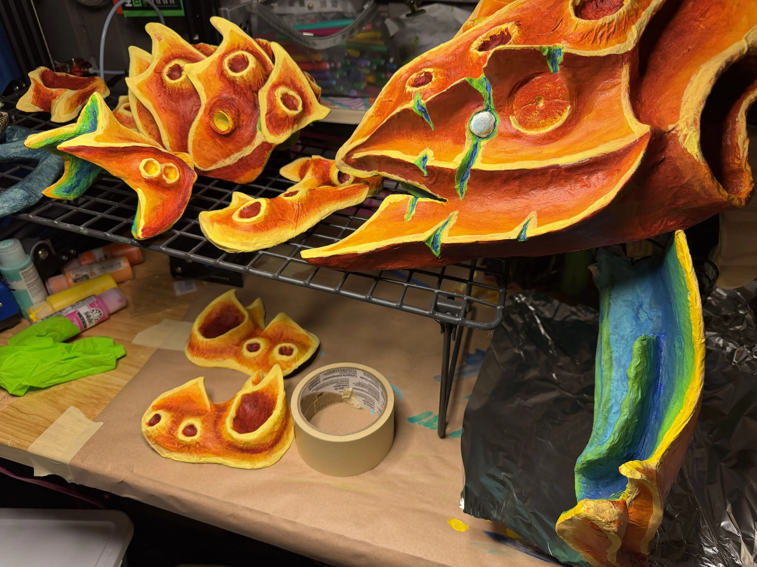 Painted alien carapaces dry in Robin Amico’s studio.